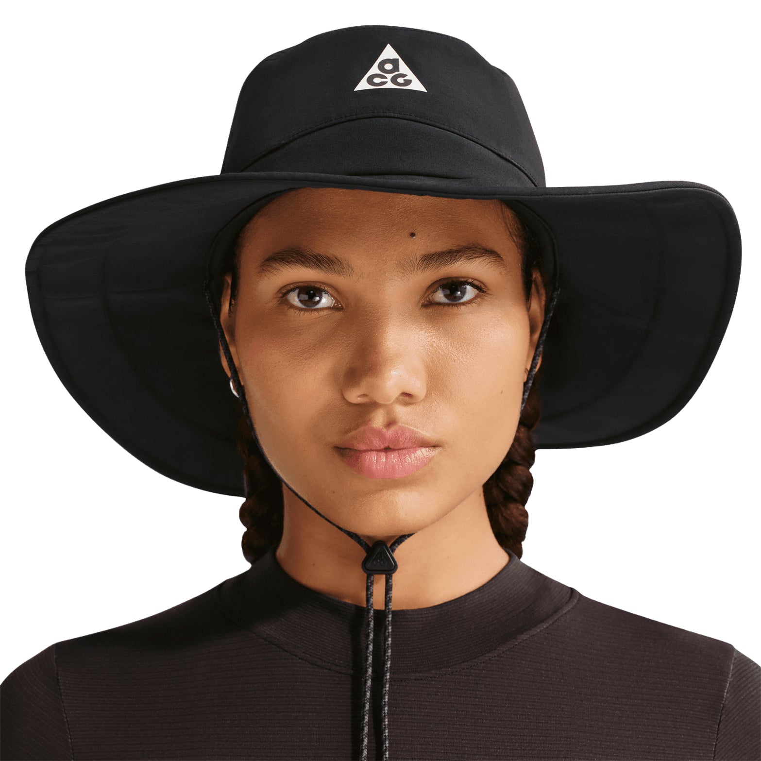 Nike ACG Apex bucket hat in Black — front view worn on female model showing black lightweight taffeta construction with wraparound brim and adjustable strap for 360-degree coverage