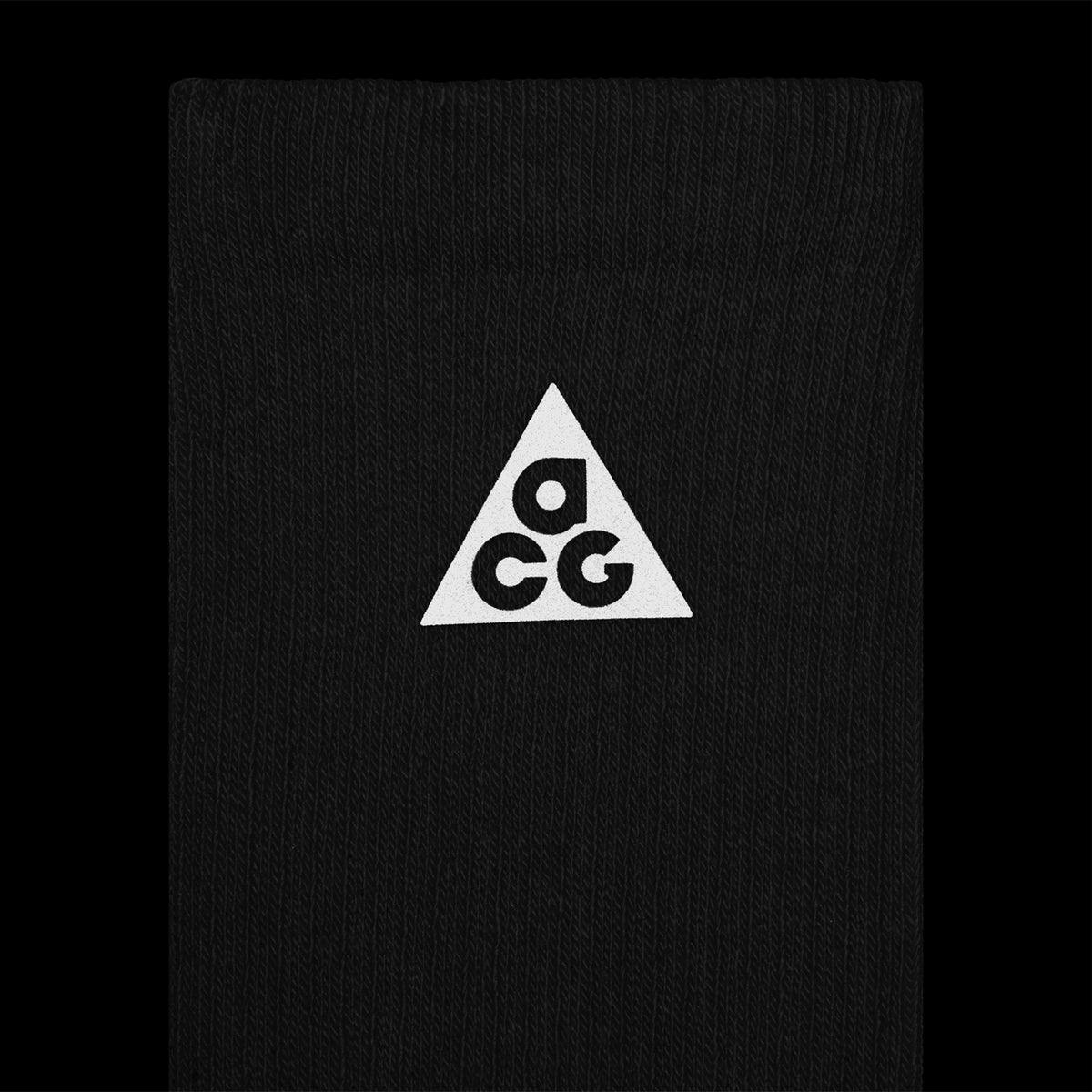 Nike ACG Everyday Elevated Crew Socks Black Dark Smoke Grey close-up of reflective logo detail showing ACG branding and visibility features