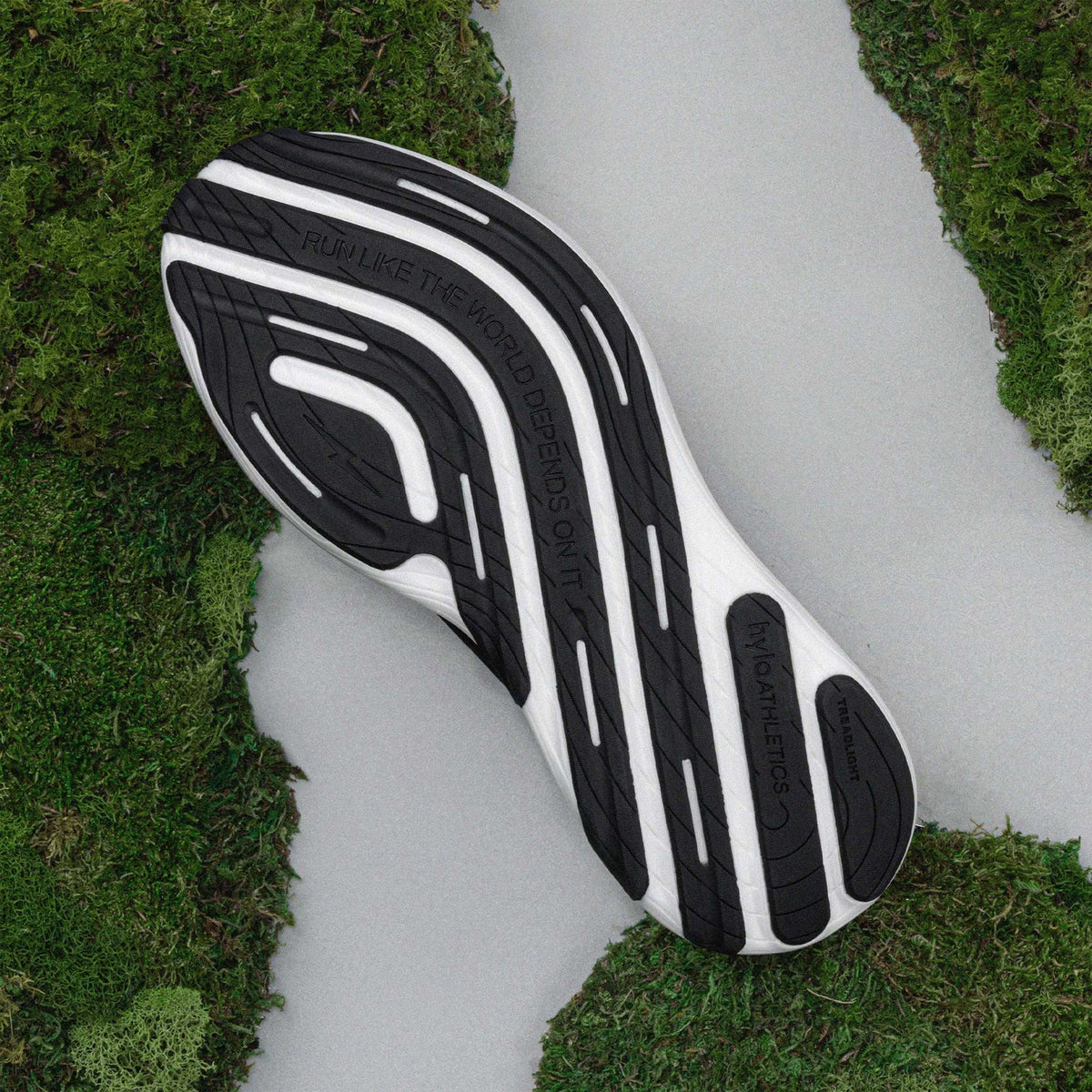 Hylo AXIS Running Shoes Black Undyed sole view displaying 60% natural rubber TreadLight outsole with redesigned tread pattern for water displacement and traction