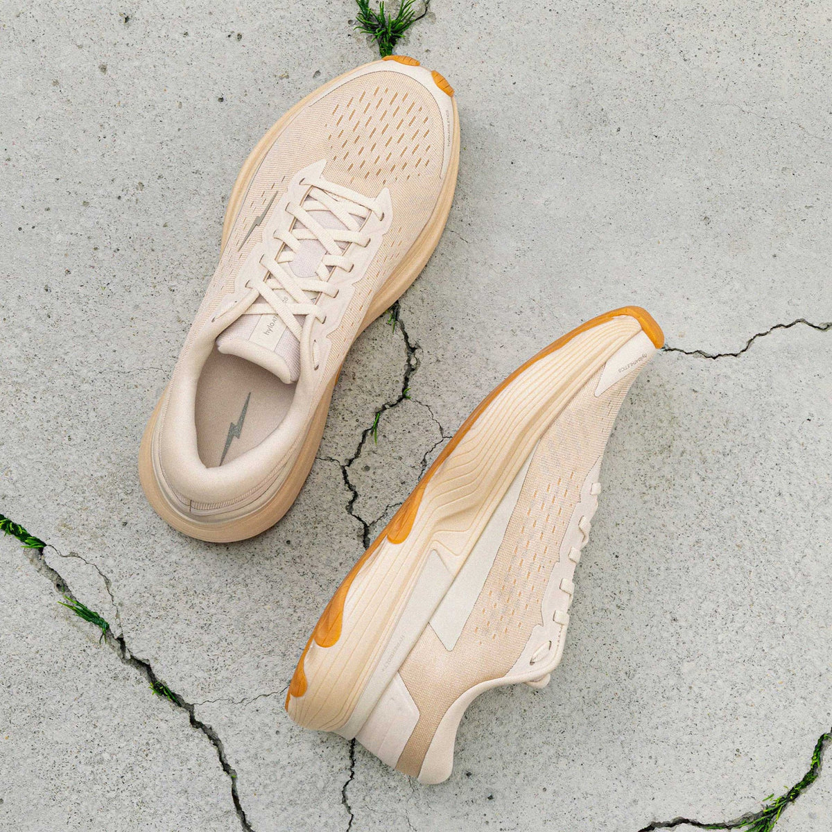 Hylo AXIS Running Shoes Beige showing top view of engineered Jacquard warp knit upper and inner side view displaying bio-based cushioning with lightweight stability