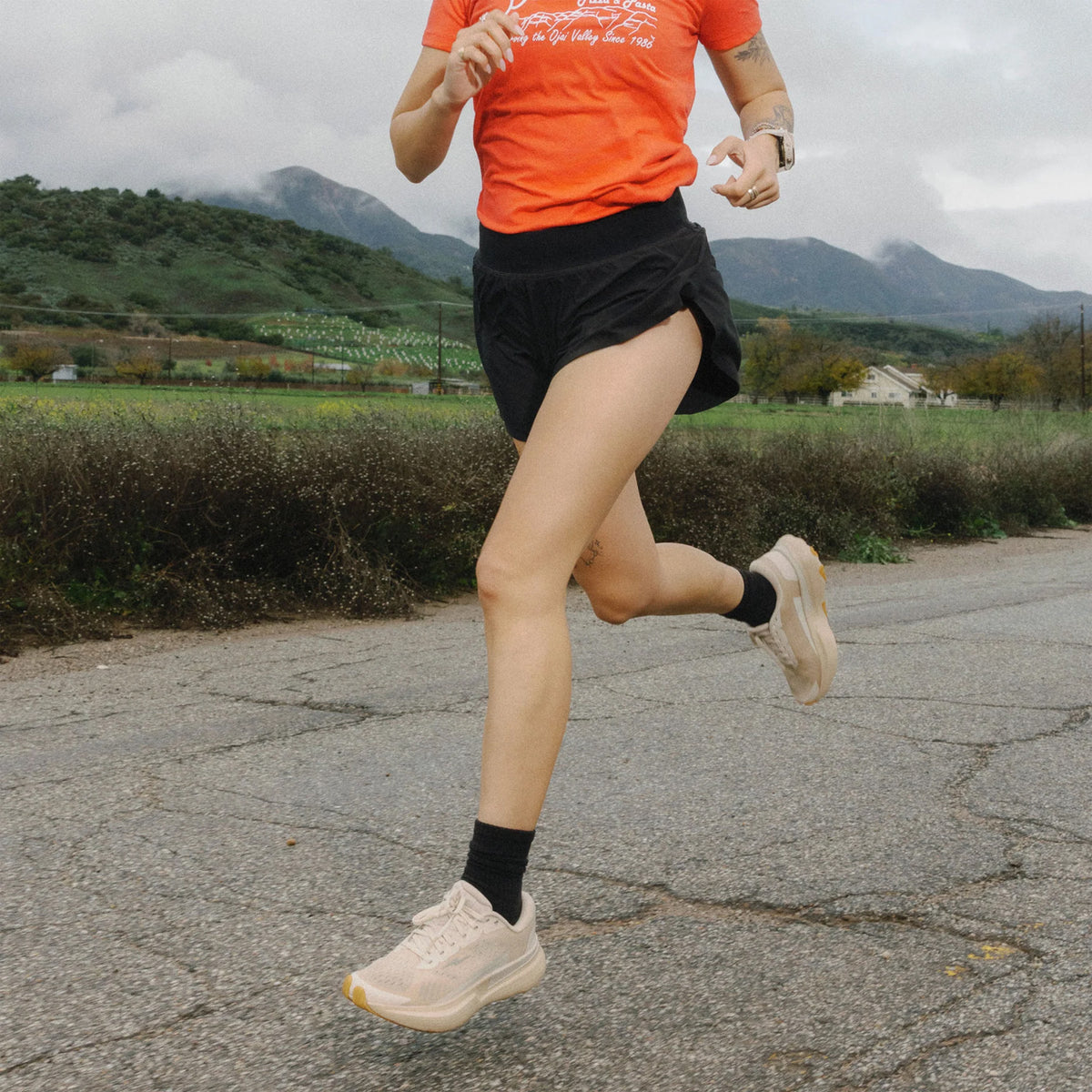 Hylo AXIS Running Shoes Beige worn by runner in motion showing 38mm stack bio-based Hyperbolt foam, smooth heel-to-toe transition and sustainable maximum cushioning performance