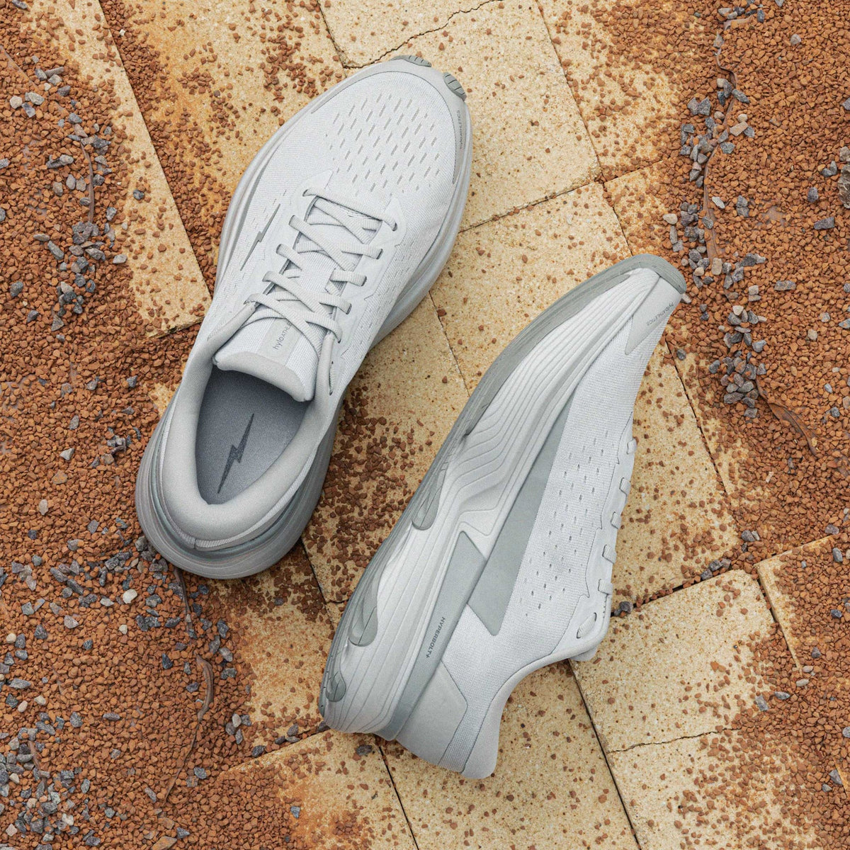 Hylo AXIS Running Shoes Grey showing top view of engineered Jacquard warp knit upper and inner side view displaying bio-based cushioning with lightweight stability