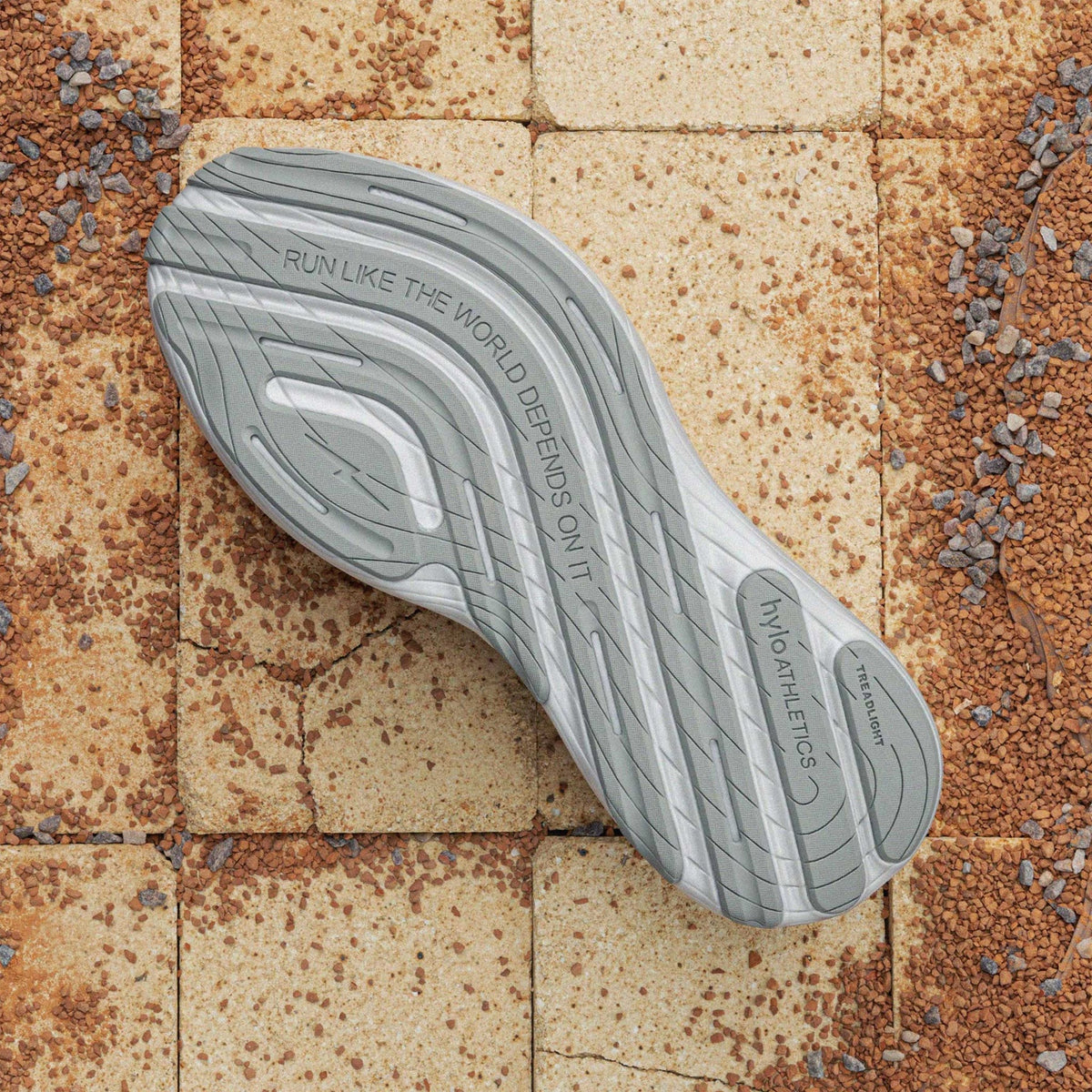 Hylo AXIS Running Shoes Grey sole view displaying 60% natural rubber TreadLight outsole with redesigned tread pattern for water displacement and traction