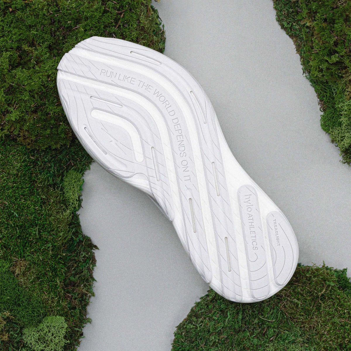 Hylo AXIS Running Shoes White Grey sole view displaying 60% natural rubber TreadLight outsole with redesigned tread pattern for water displacement and traction