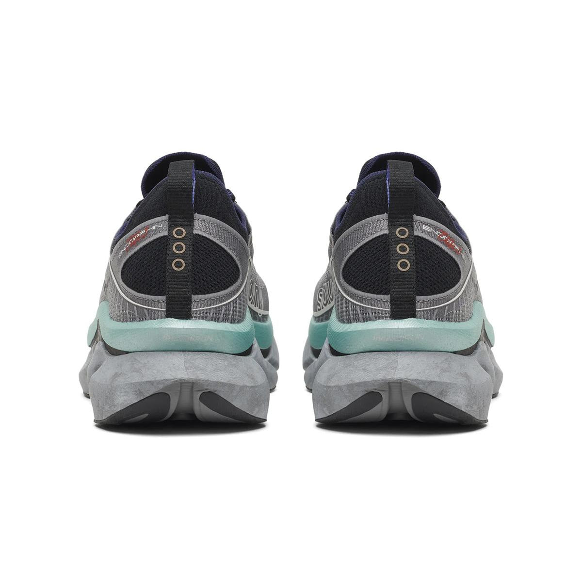 A pair of Saucony Endorphin Elite 3 Running Shoes in Owl / Black, viewed from the back, featuring gray soles, teal and black accents, and circular details on the heels—these athletic sneakers are renowned for their innovative design and carbon fibre plate that enhances performance.