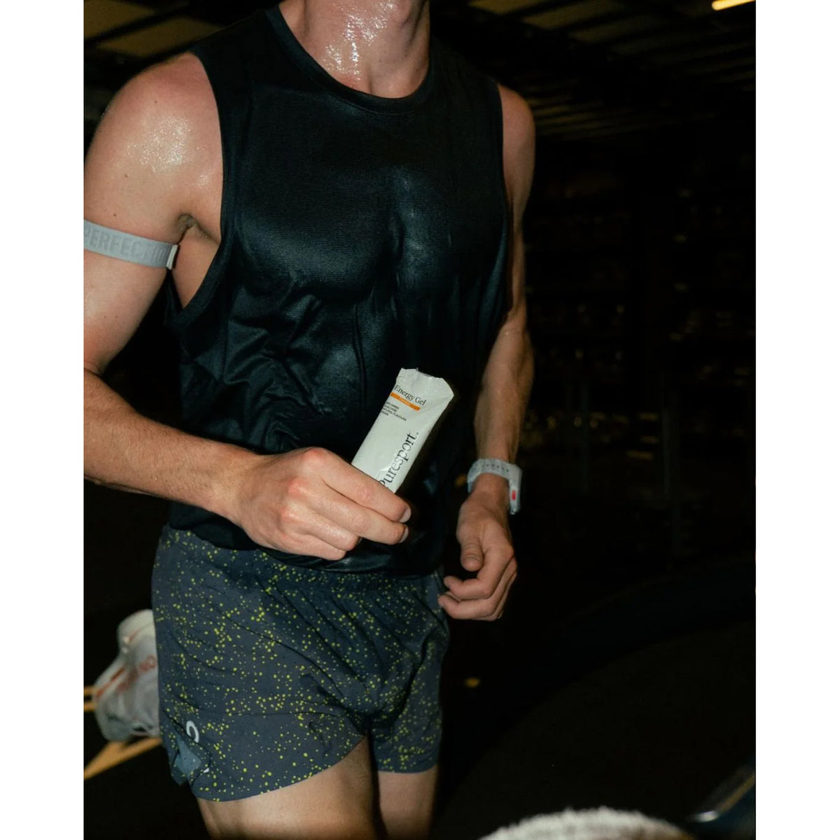 Puresport Energy Gel Unflavoured — action shot showing runner consuming DualCarb™ energy gel during road running effort