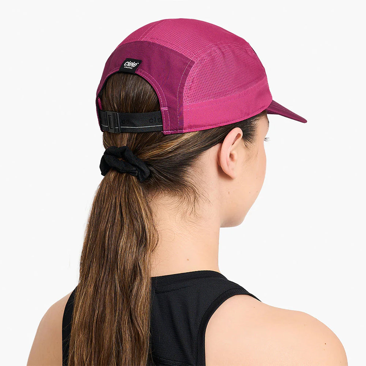 Ciele GOCap Comp Century Mulberry Bocasana back view on runner showing reflective detailing for night run visibility with fast-drying mesh construction