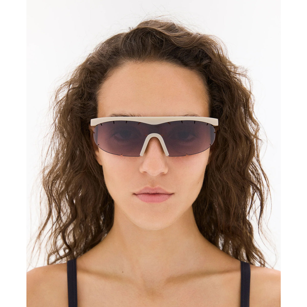 District Vision x PAF Koharu Eclipse in Sand D+ Black Rose Gradient — worn on female model showing six-base blade-style frame fit, sand colourway and D+ Black Rose Gradient lens in natural light