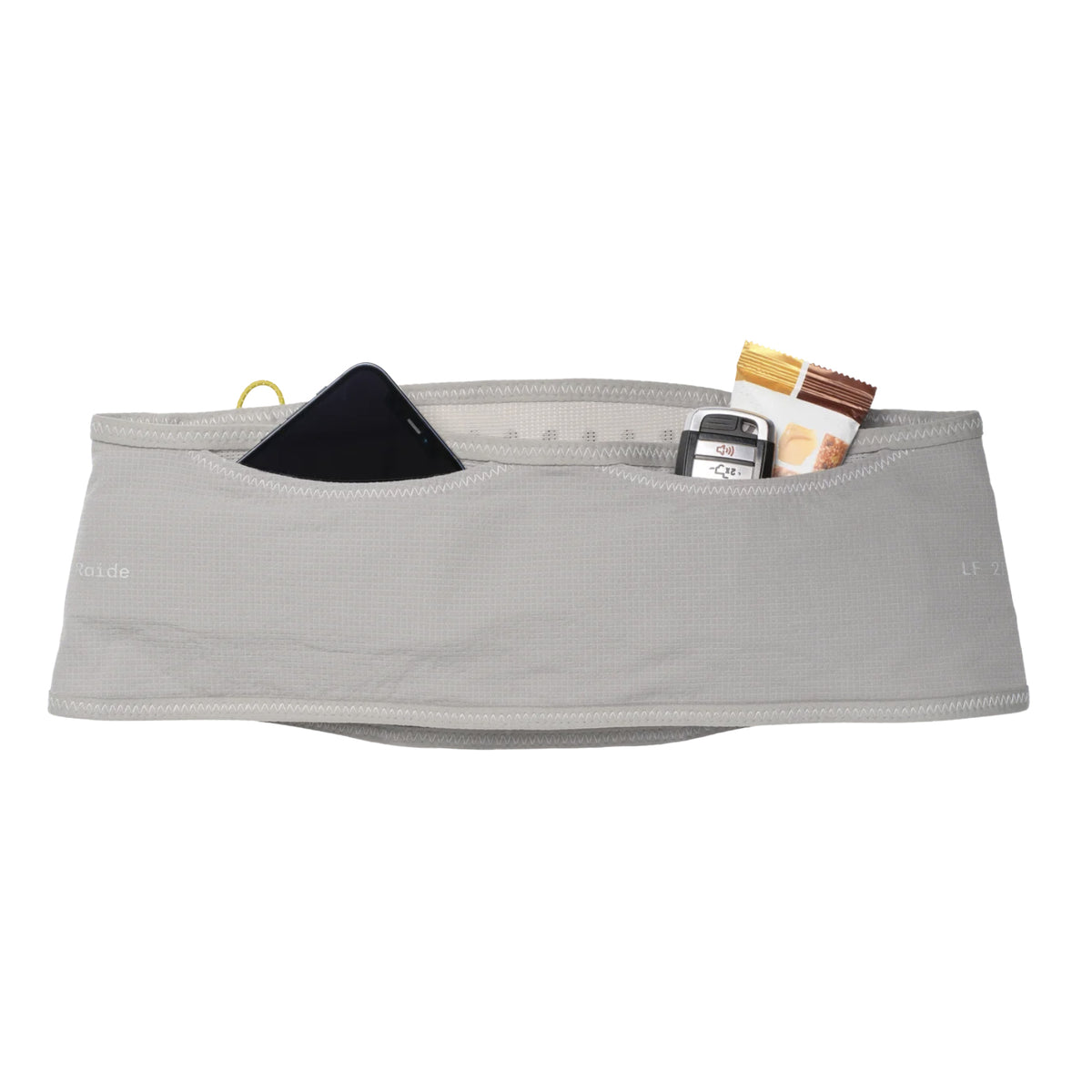 The Raide LF 2L Running Belt Stone is a gray, vest-free running belt with pockets displaying a black smartphone, a set of keys, and a nutrition bar against a white background. This bounceless belt features Raide’s zero bounce suspension system for maximum comfort during your run.