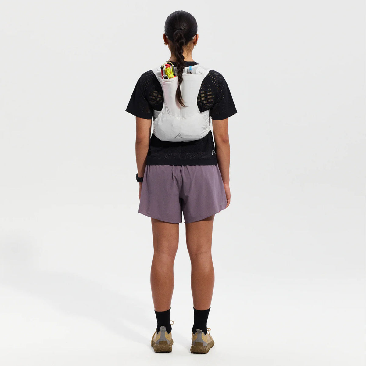 Raide LF 5L Running Vest in White — full body back view worn on model showing rear hydration carry, integrated ice tool carry with axle toggle and rear passthrough pocket construction