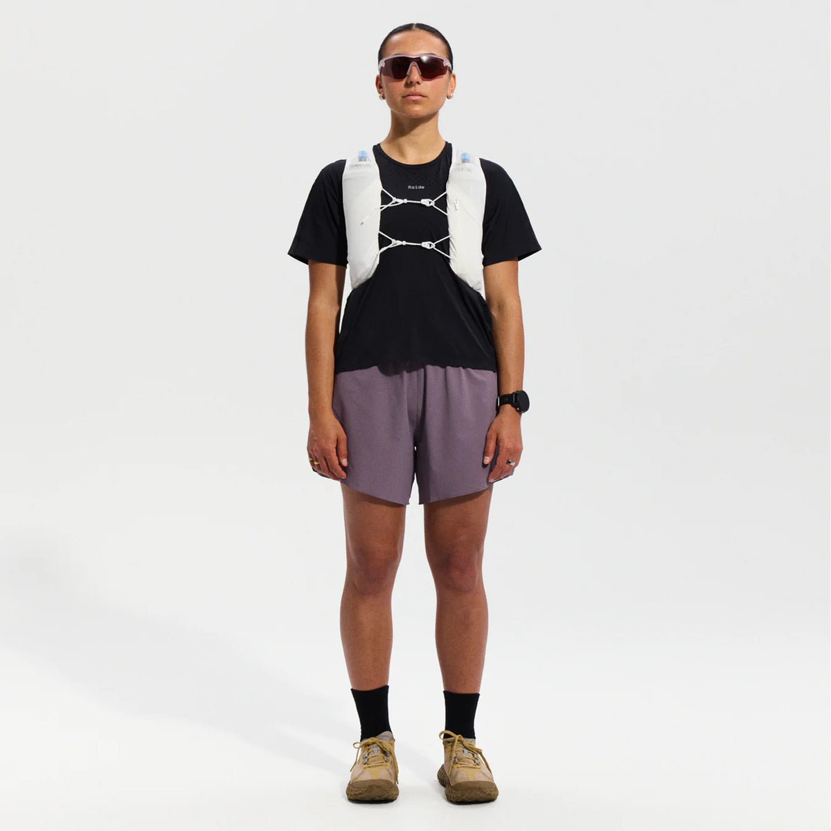 Raide LF 5L Running Vest in White — full body front view worn on model showing integrated pole quiver, chest tension system and 5L storage capacity with white DyneemaⓇ mesh construction