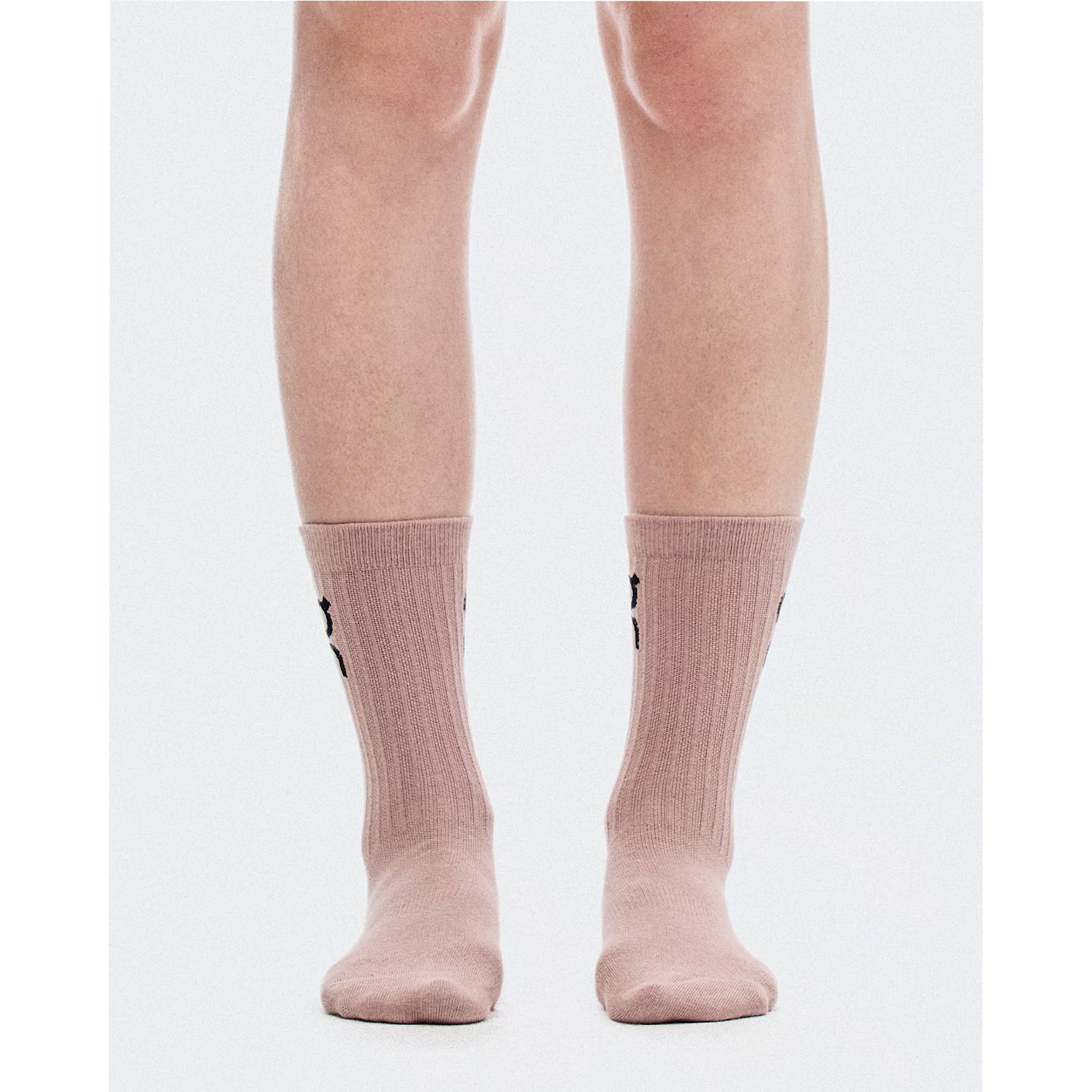 A pair of legs wearing On Logo Socks High 3 Pack in Sherbet / Rhodonite, featuring light pink ribbed arch support, viewed from the front against a plain white background.