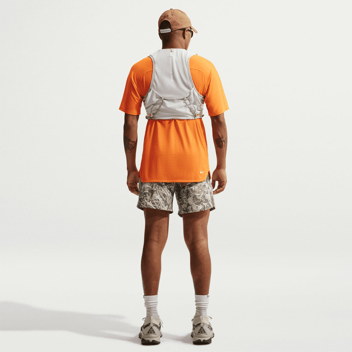 Men's Nike ACG 6 Inch Running Shorts Sequoia Light Army Summit White back full body view on male trail runner showing four drop-in pockets with lightweight ACG construction for trail running and outdoor activities