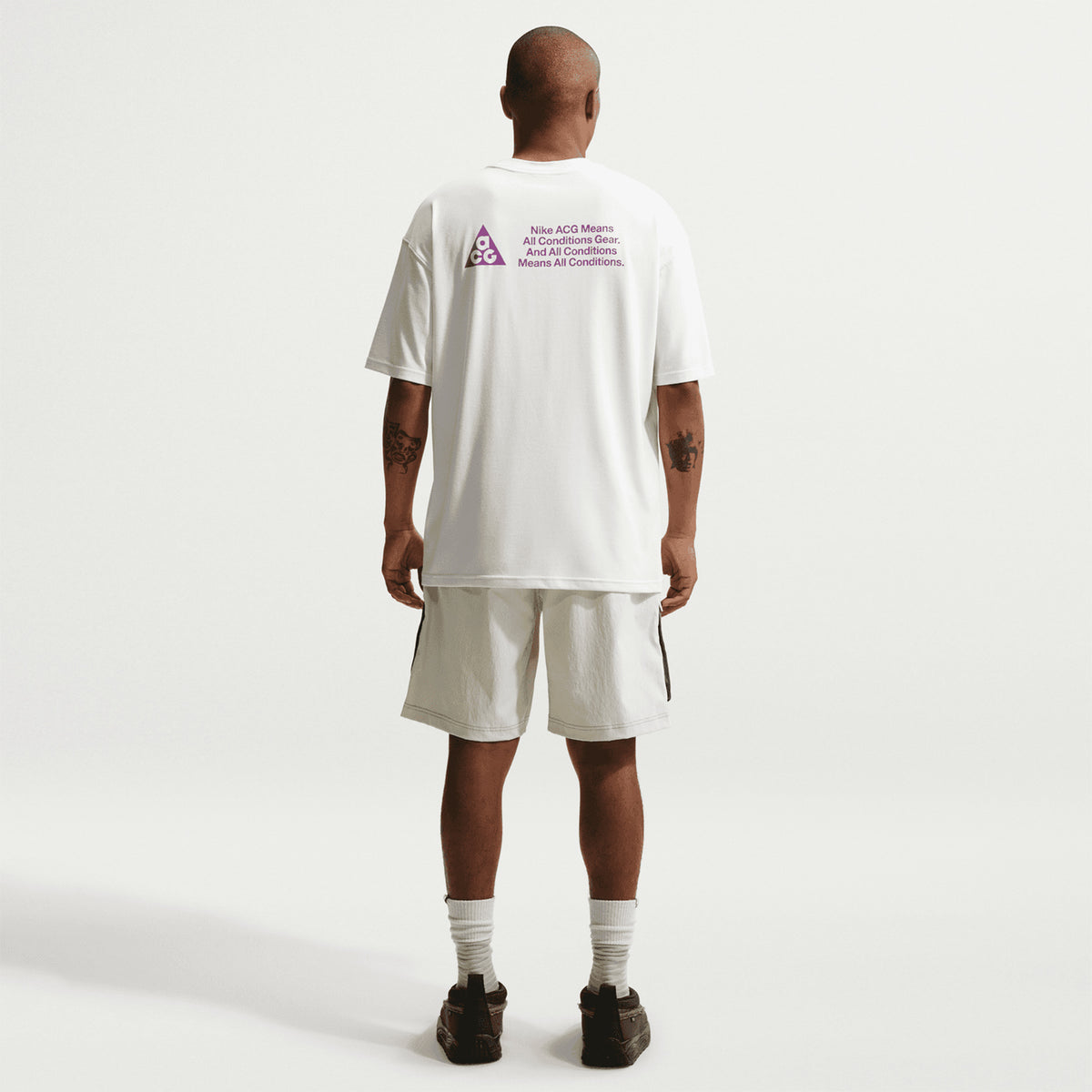 Men's Nike ACG Dri-FIT Tee Summit White full body back view on male runner showing breathable Dri-FIT construction for all-conditions trail running and mountain wear