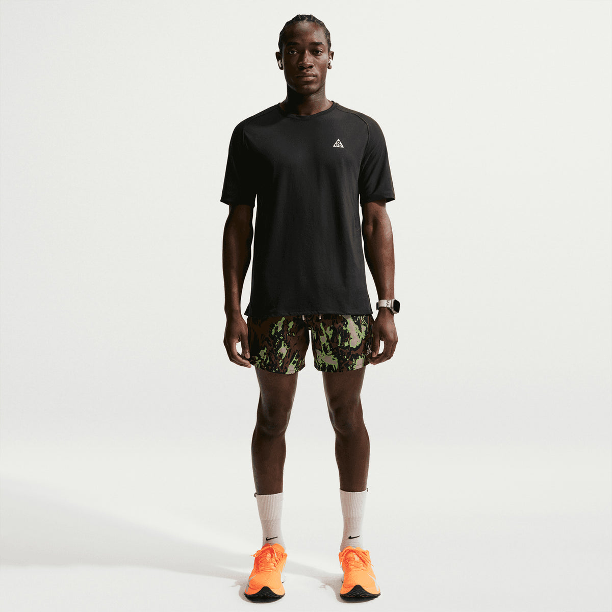 Men's Nike ACG Solar Chase Dri-FIT ADV Trail Running Tee Black Summit White full body view on male trail runner showing lightweight cotton-poly construction with Dri-FIT ADV technology for comfortable outdoor running