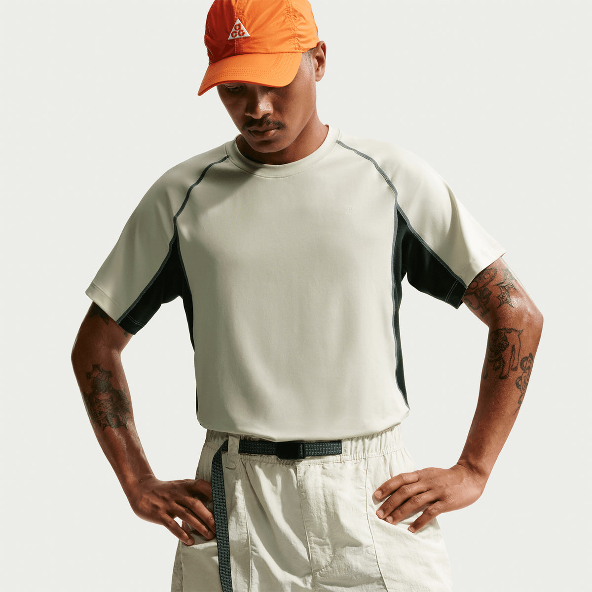 Men's Nike ACG Wildsee Dri-FIT Base-Layer Tee Sea Glass Black Spruce Summit White front view on male model showing snug base layer fit with UV-resistant Dri-FIT fabric for trail running and mountain activities