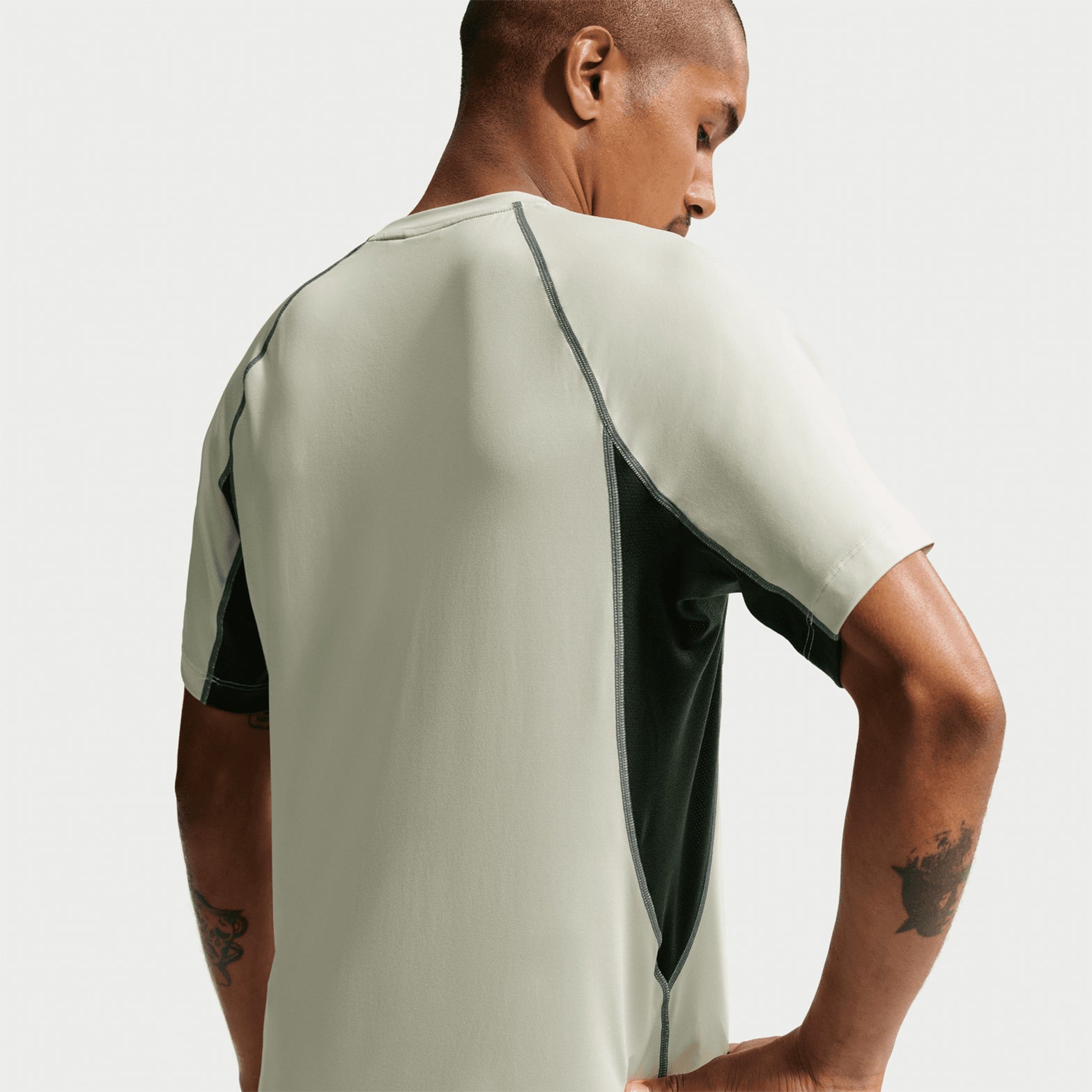 Men's Nike ACG Wildsee Dri-FIT Base-Layer Tee Sea Glass Black Spruce Summit White back view showing sweat-wicking construction with ACG nesting system design for layering or solo wear
