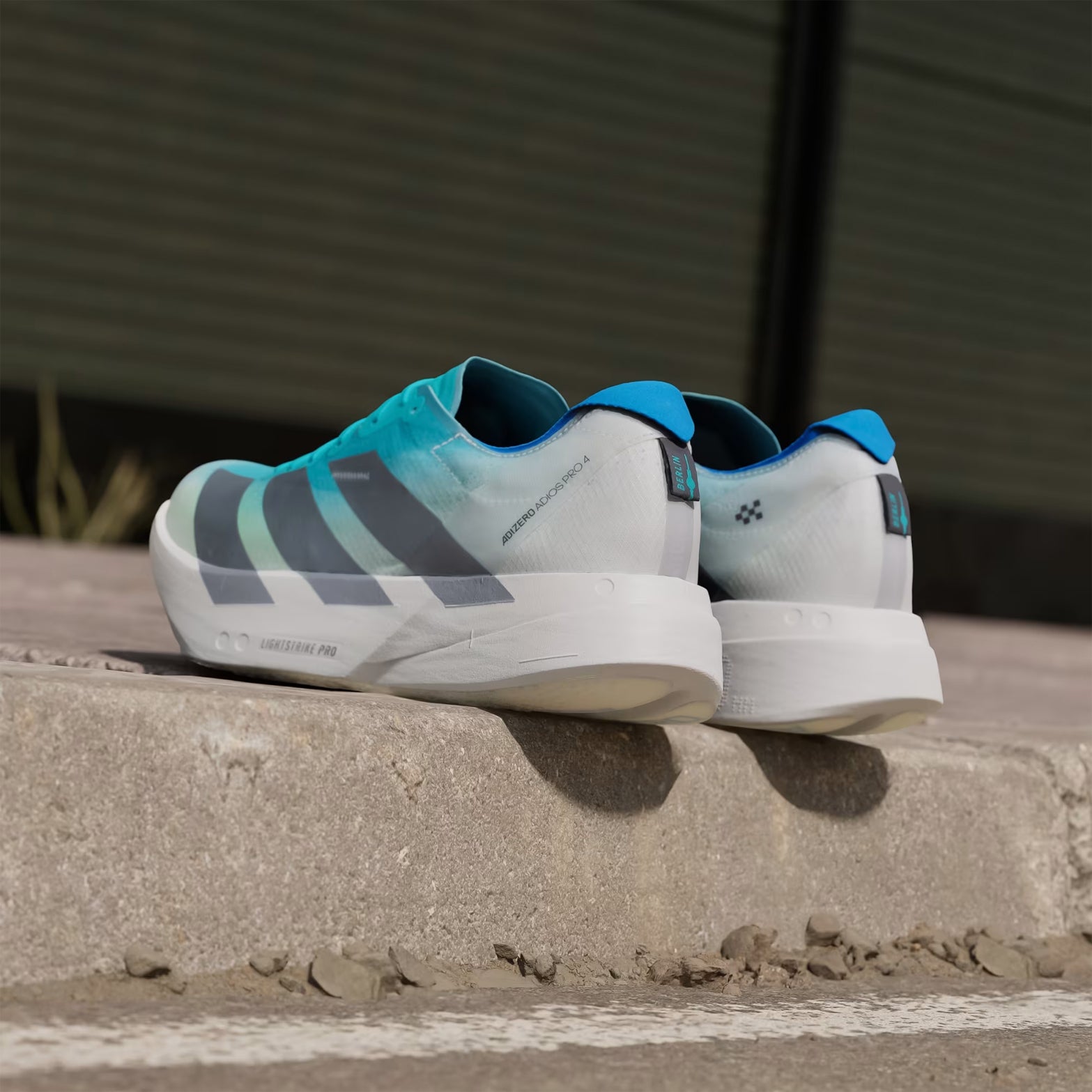 Men's Adizero Adios Pro 4 Running Shoes Hi-Res Aqua Iron Metallic Grey One pair angled heel view showing lightweight construction