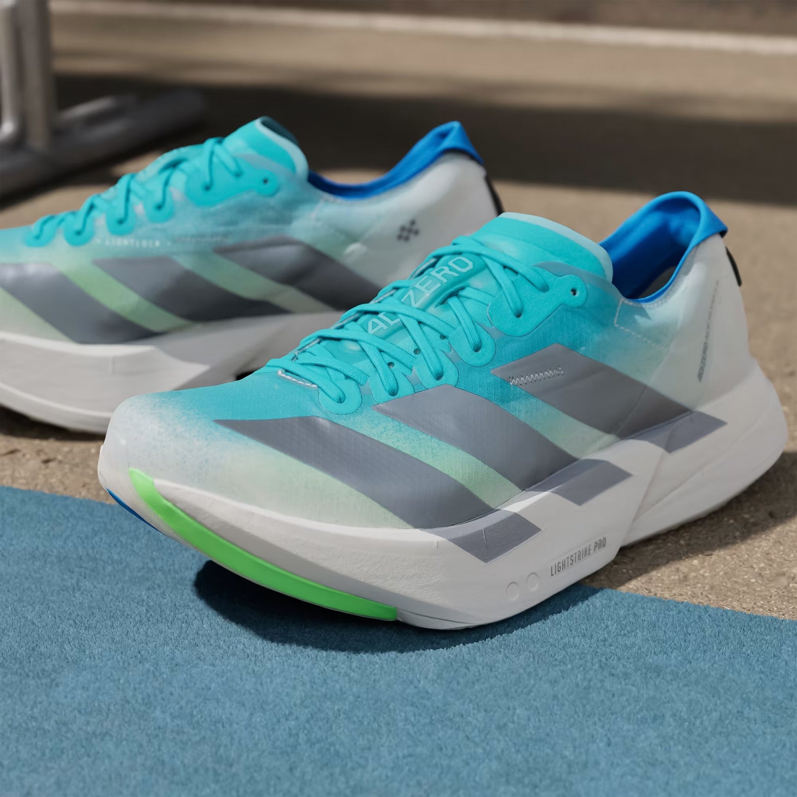 Men's Adizero Adios Pro 4 Running Shoes Hi-Res Aqua Iron Metallic Grey One pair outer side view displaying racing shoe profile