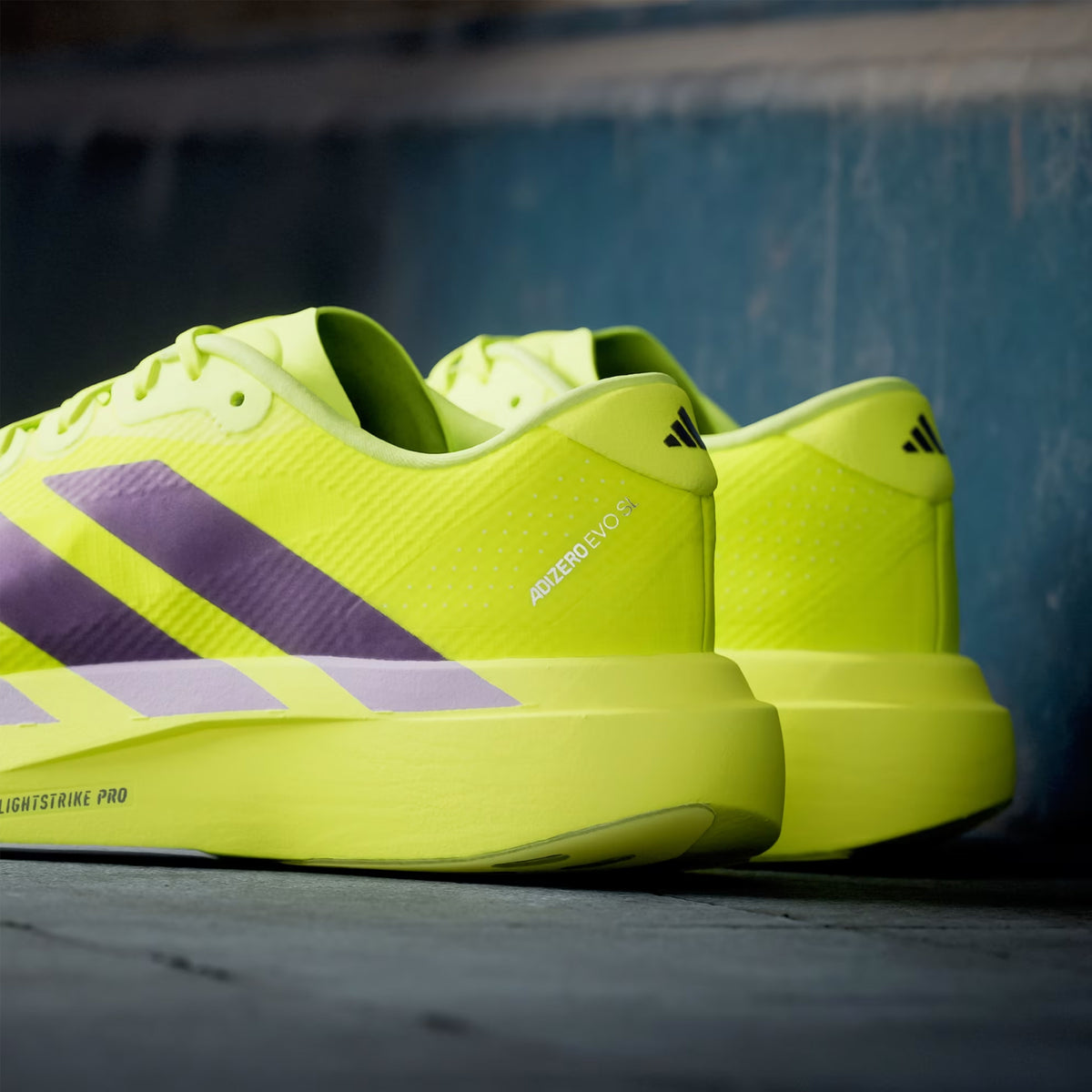Men's adidas Adizero EVO SL Woven Running Shoes Solar Yellow Aurora Plum Powder Plum heel view showing LIGHTSTRIKE PRO foam stack with woven upper construction and racing-inspired design