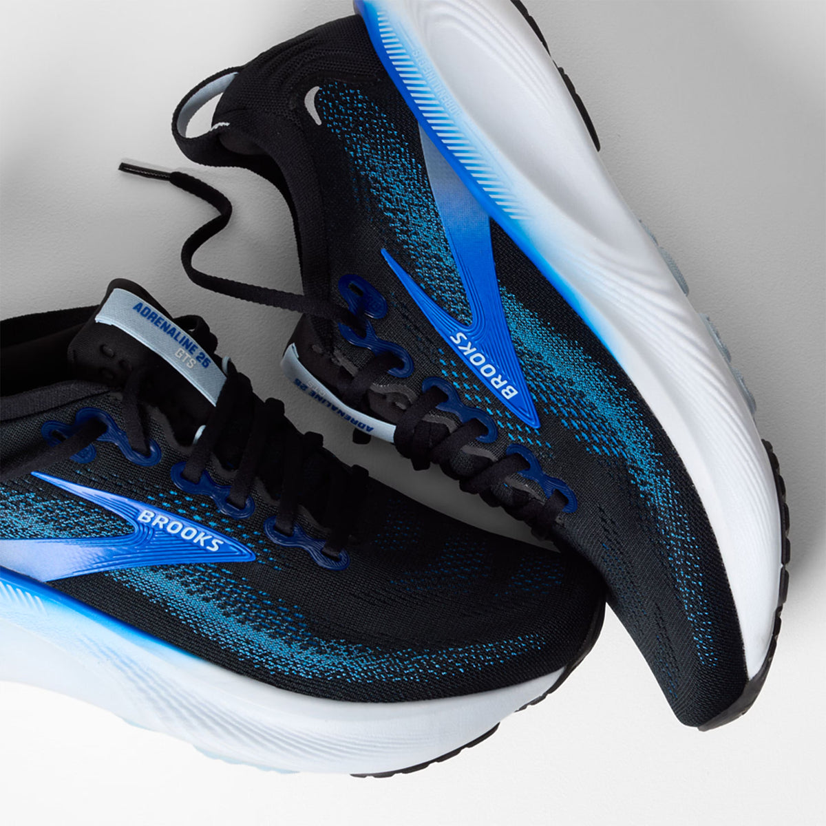 Men's Brooks Adrenaline GTS 25 Running Shoes Black Blue Nantucket Breeze angled side view of pair showing nitrogen-infused DNA LOFT cushioning with GuideRails support and engineered mesh upper for reliable comfortable road running