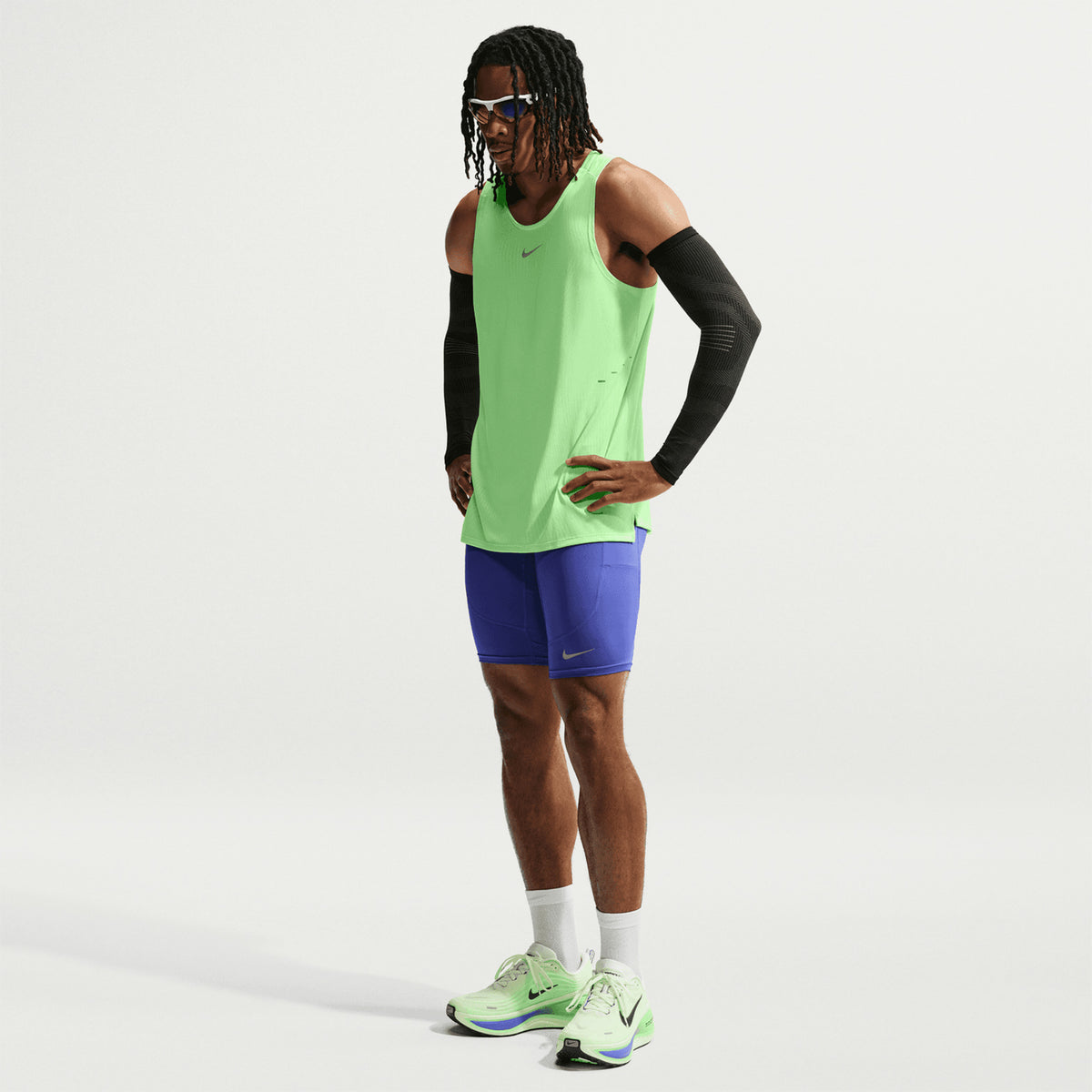Men's Nike Aero-FIT Running Vest Volt Light Silver Reflective Silver front full body view on male runner showing lightweight knit with Aero-FIT mesh zones for maximum breathability and cooling during running