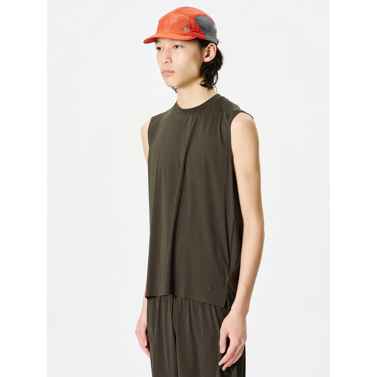 Goldwin Men's Air Pit Tank Jet Brown side view on male model showing bonded seams at armholes and relaxed fit for airflow inside garment