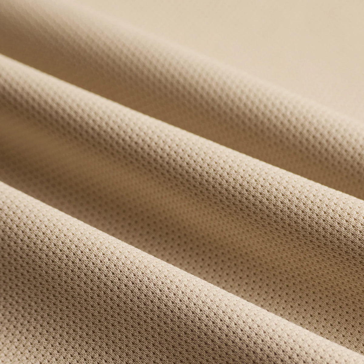 District Vision Short Sleeve Boxy Training Tee Beige close-up of 139g breathable stretch fabric