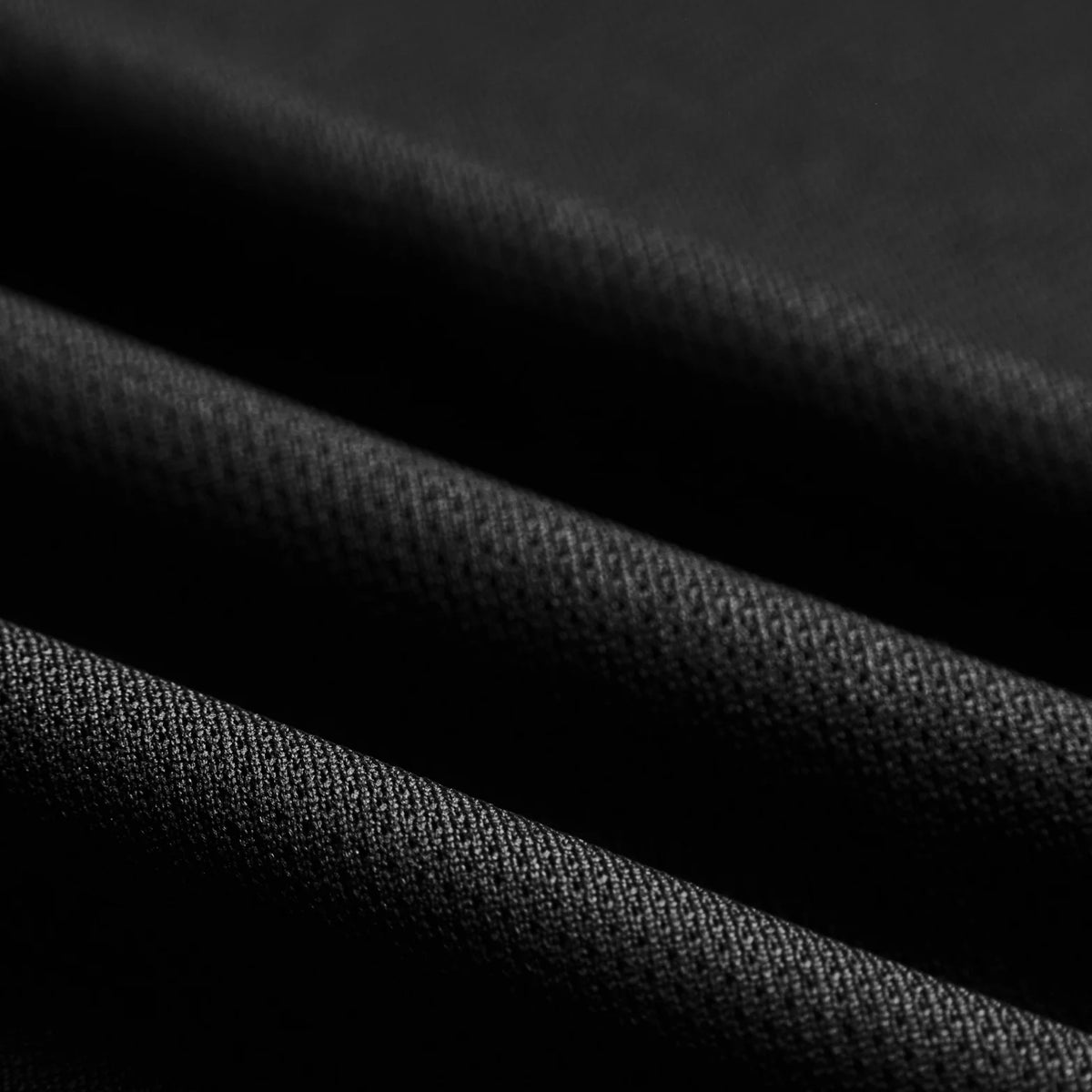District Vision Men's Boxy Training Tee Black close-up of 139g breathable stretch fabric showing moisture management construction with durable overlock stitching for all athletic pursuits