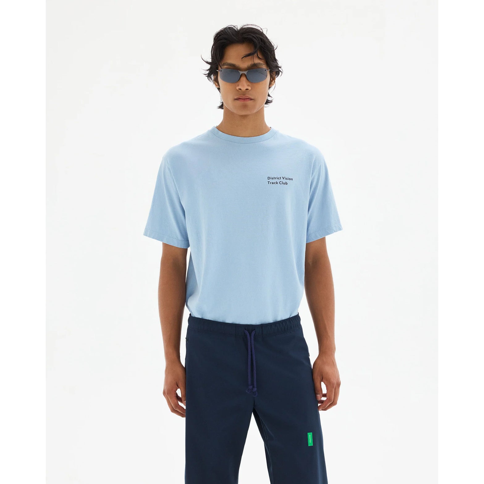 District Vision California Cotton Tee men's in Track Club Light Blue — front view worn on model showing relaxed fit, Track Club graphic print and light blue pigment dye stone wash cotton drape