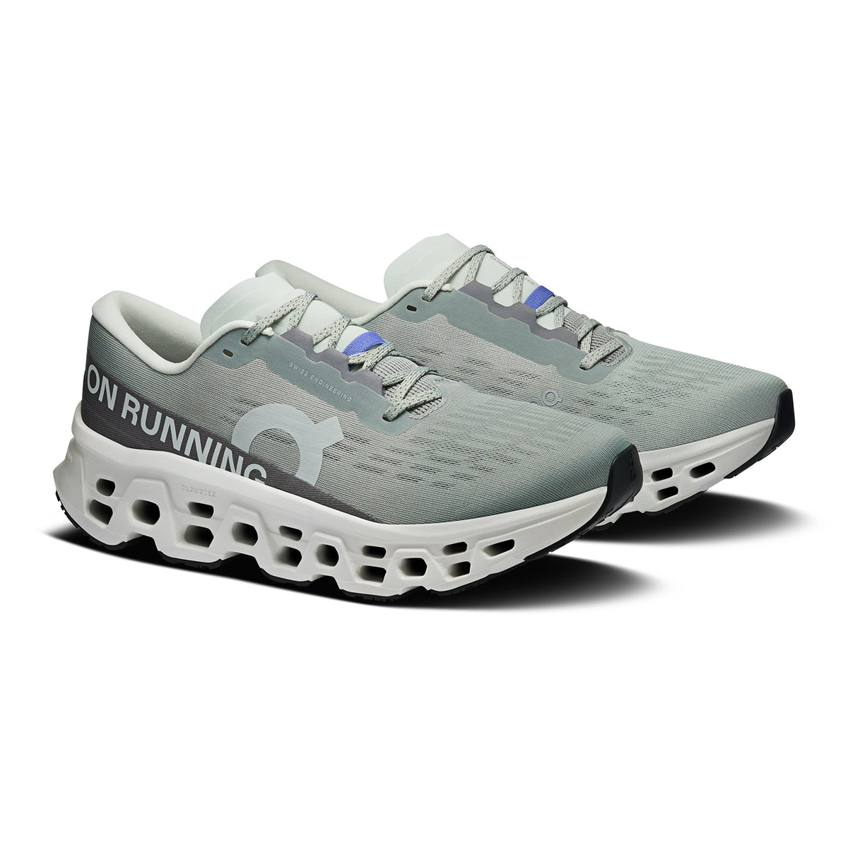 On Cloudmonster 3 men's running shoe in Tin / Ivory — angled side view showing tin grey engineered knit upper, Speedboard® profile, enhanced rocker geometry and ivory triple-layer CloudTec® Helion™ foam midsole stack