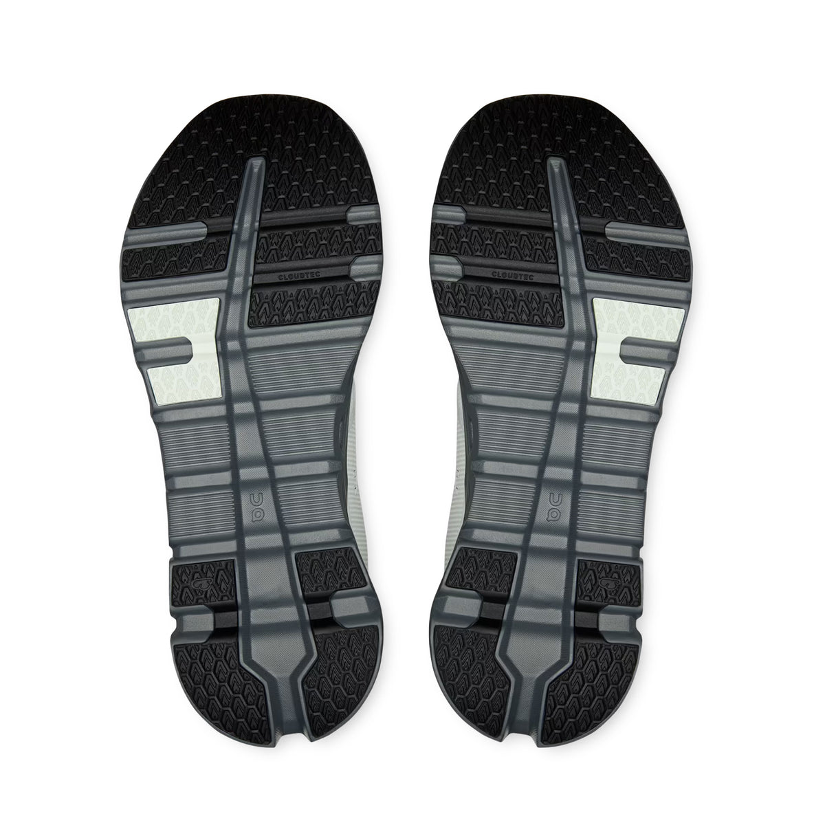 Pair of Iceberg/Rock Cloudrunner 2 Waterproof Running Shoes by On shown from the bottom in black and gray, featuring textured treads, grooves, and patterned designs for superior traction—engineered for all-weather stability with CloudTec cushioning to enhance comfort across any terrain.