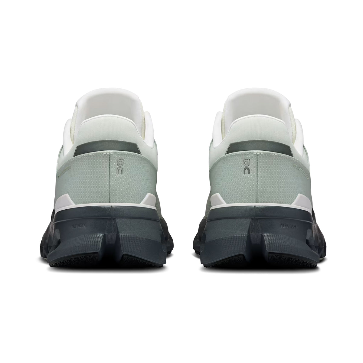 A pair of On Men’s Cloudrunner 2 Waterproof Running Shoes in Iceberg / Rock is displayed side by side on a clean white background. Shown from the back, these athletic sneakers feature light gray and white uppers with thick dark soles and the signature On brand logo on the heel. Engineered with CloudTec cushioning, they deliver superior comfort and all-weather stability.