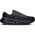 The Men’s Cloudrunner 3 Waterproof Running Shoes by On feature a sleek black design with a breathable mesh upper, lace-up closure, and a thick sole showcasing large horizontal cutouts for enhanced cushioning and support. The On brand logo stands out on the side, while innovative CloudTec cushioning provides exceptionally smooth and comfortable strides.