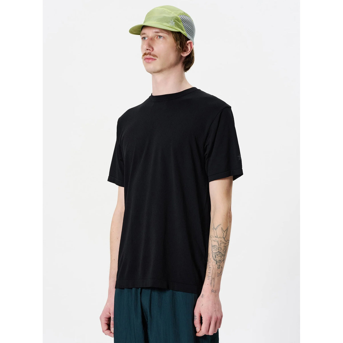 Goldwin Men's Convexity Dry Tee side view on male model showing seamless construction with denser weave in armpit zones for enhanced comfort