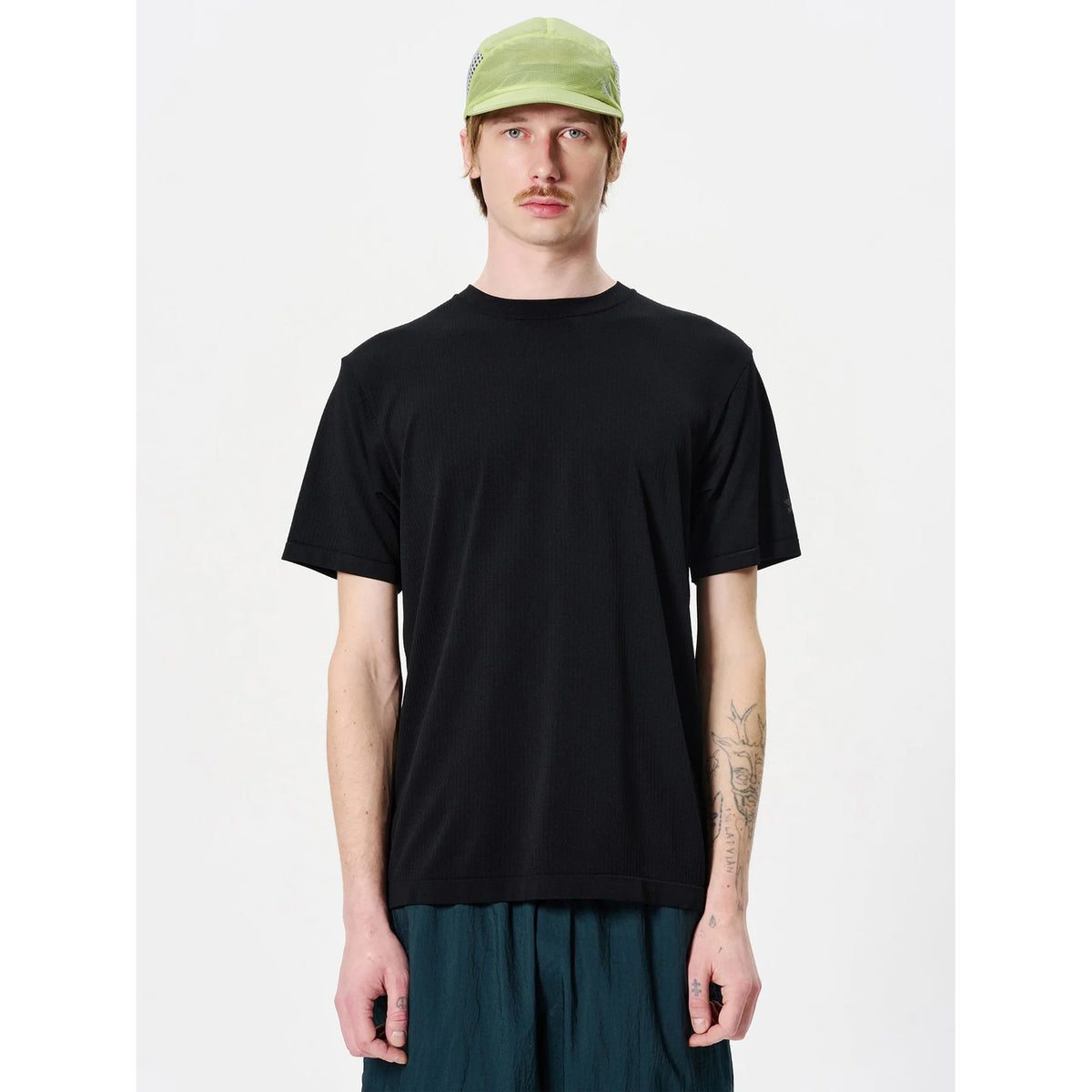 Goldwin Men's Convexity Dry Tee front view on male model showing seamless tubular construction with dual-layer technical knit fabric for moisture management during running and training