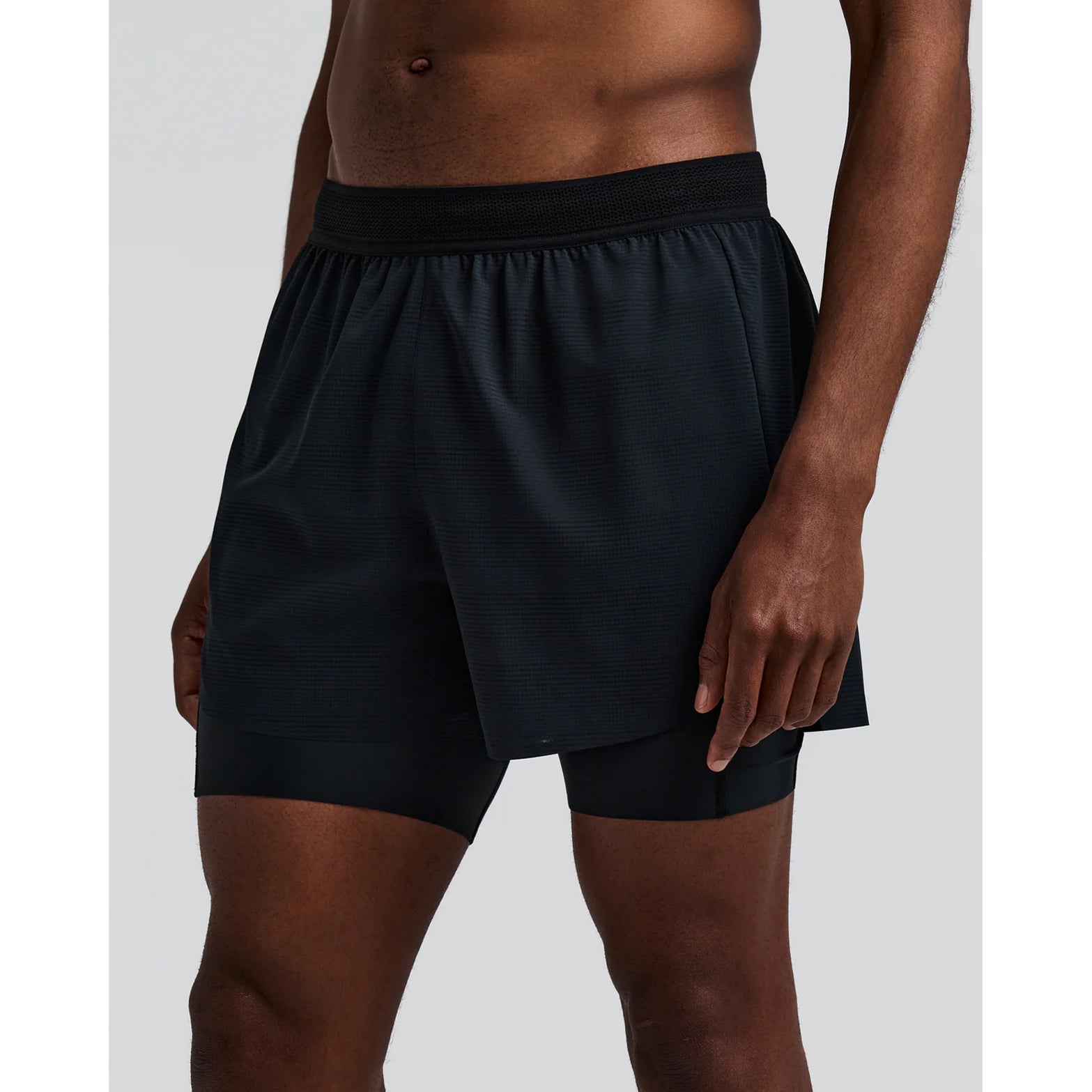 Men's Bandit CoolGrid 2-in-1 Run Short Black front view on male runner showing CoolGrid breathable outer with mesh waistband and waterproof leg phone pockets