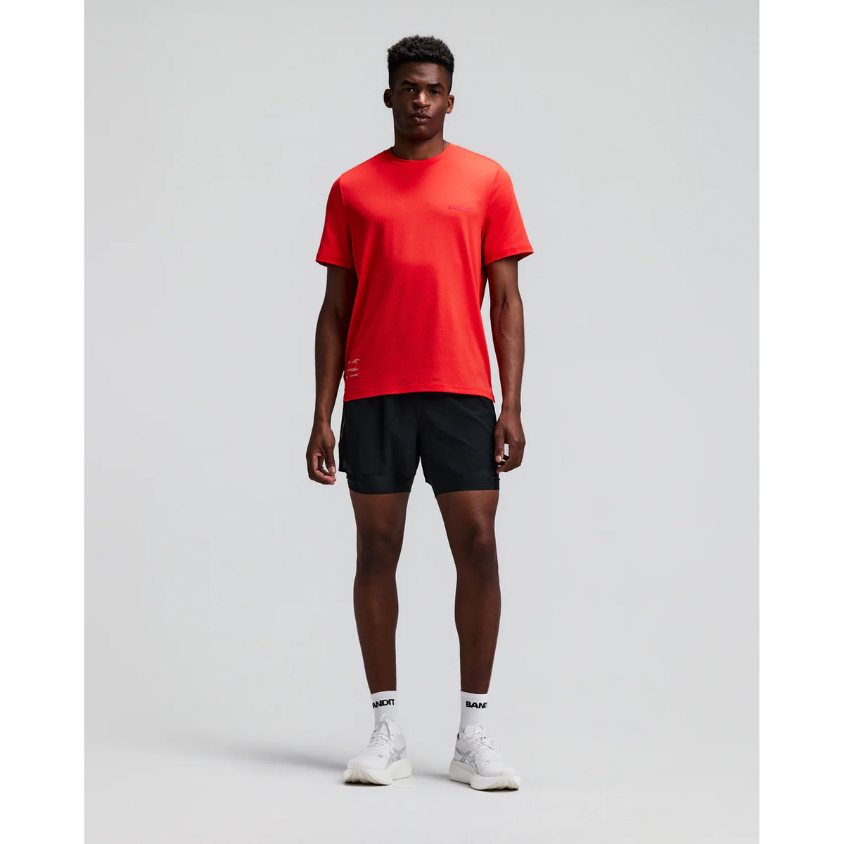 Men's Bandit CoolGrid 2-in-1 Run Short Black front full body view on male runner showing 2-in-1 CoolGrid outer with moisture-wicking liner and six-pocket system for road running and racing