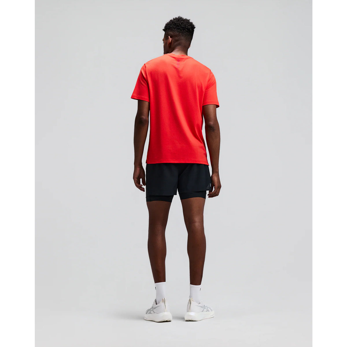 Men's Bandit CoolGrid 2-in-1 Run Short Black back full body view on male runner showing GripDot hem grip with reflective centre back branding and CoolGrid breathable construction