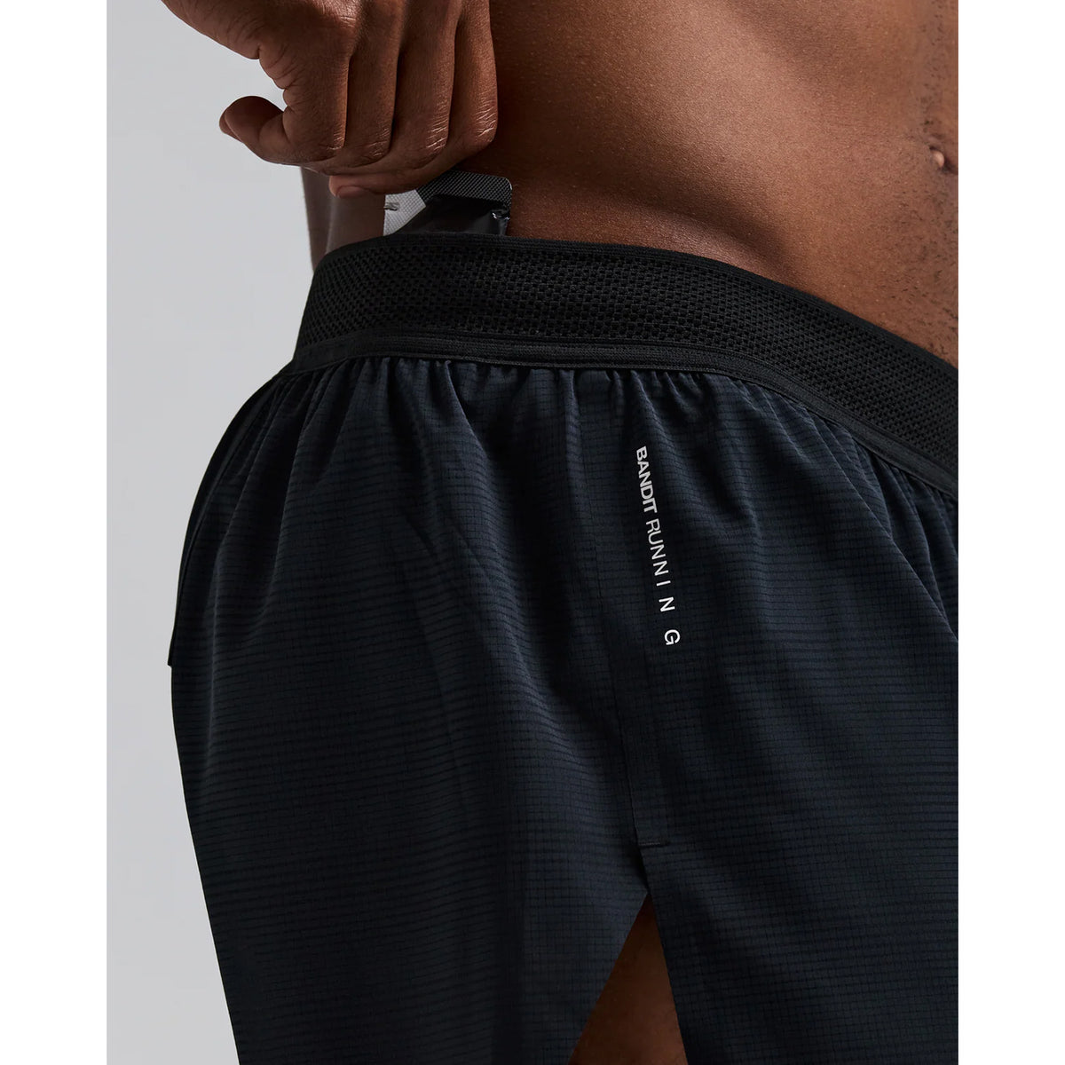Men's Bandit CoolGrid 3 Inch Split Shorts Black close-up of pocket system showing waterproof phone pocket, four gel pockets and key fob pocket with zero-bulk design for running essentials