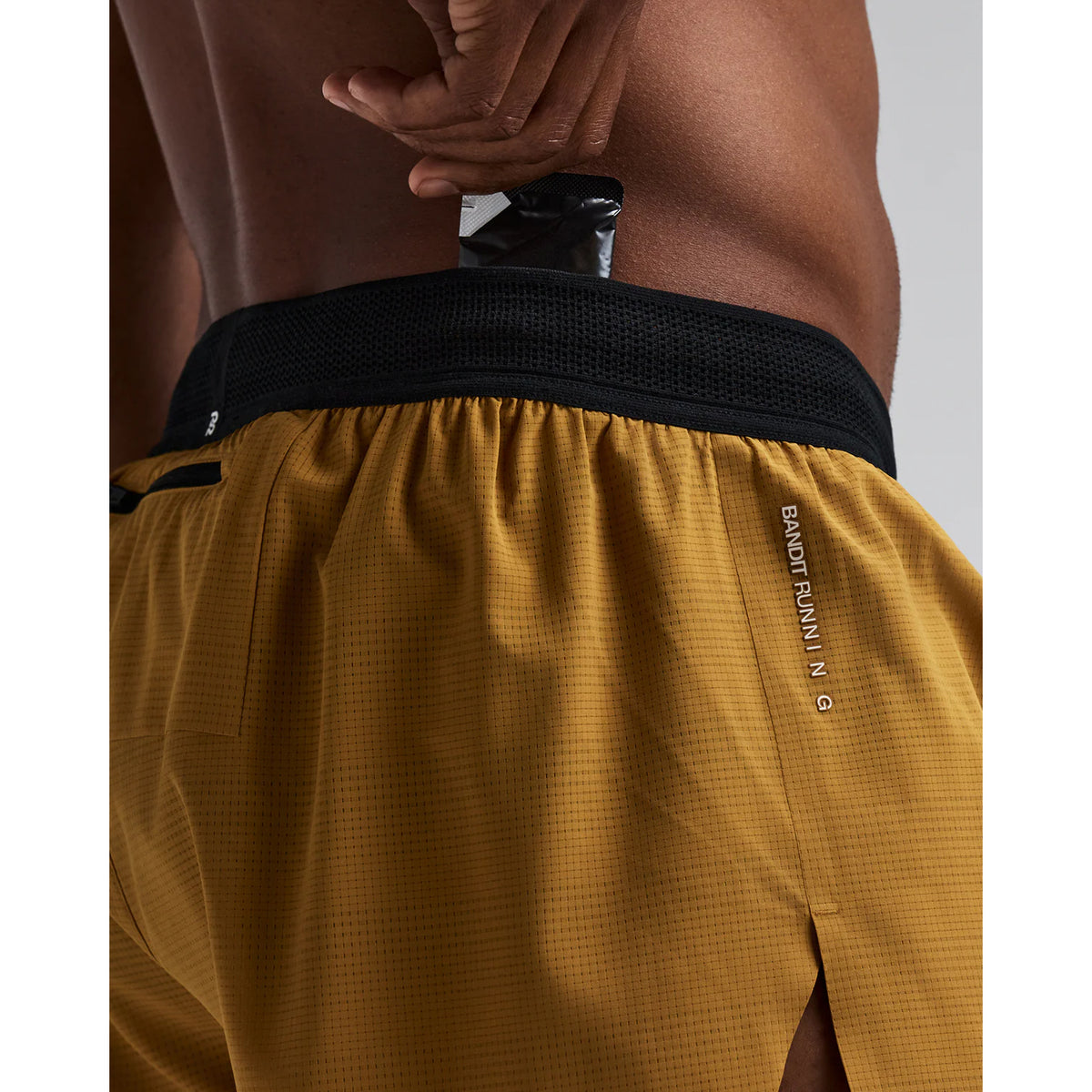 Men's Bandit CoolGrid 3 Inch Split Shorts Copal close-up of pocket system showing waterproof phone pocket, four gel pockets and key fob pocket with zero-bulk design for running essentials