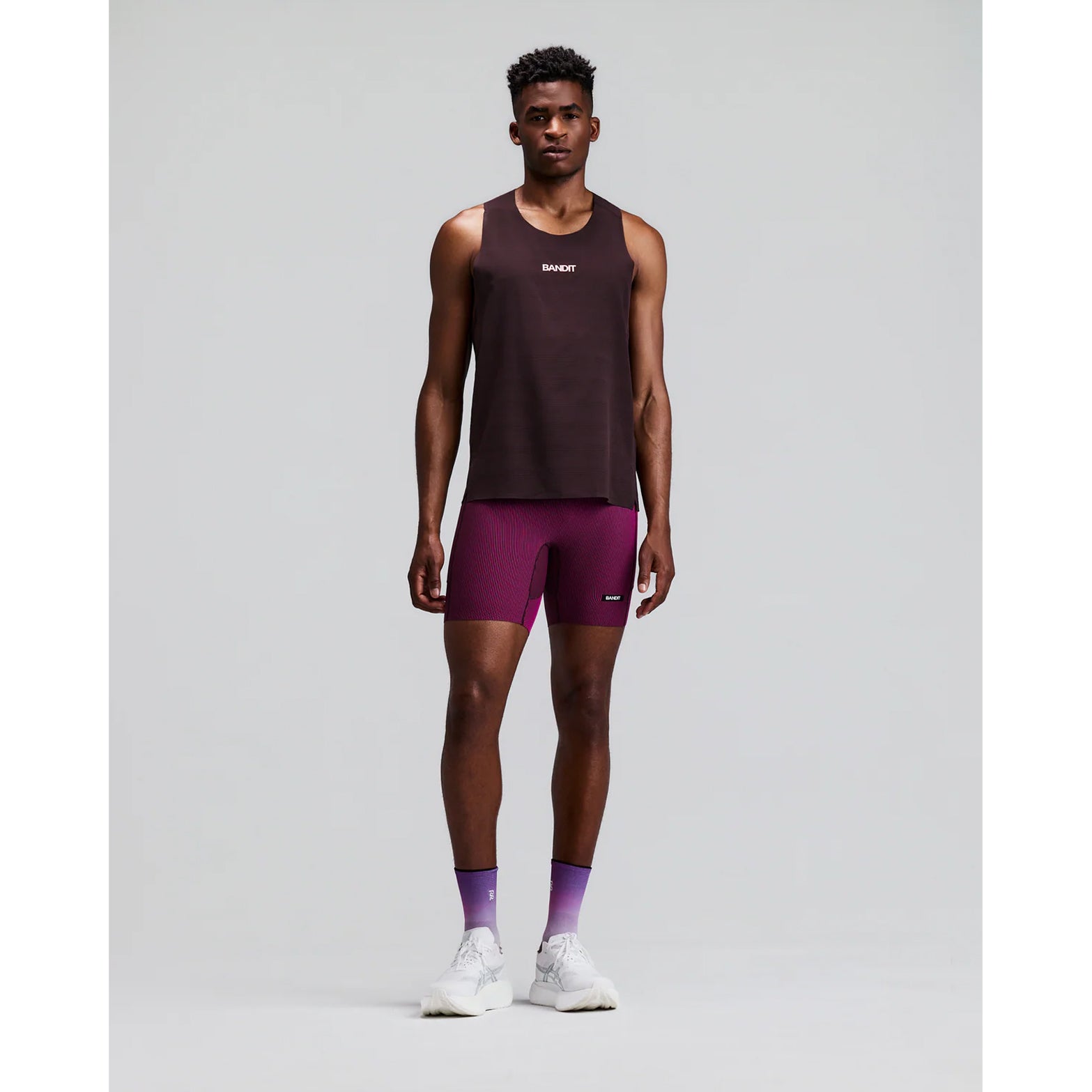 Men's Bandit CoolGrid Training Singlet with Flopack Espresso front full body view on male runner showing CoolGrid breathable mesh with high neckline, filled-in racer back and side slits for cool to hot temperature training