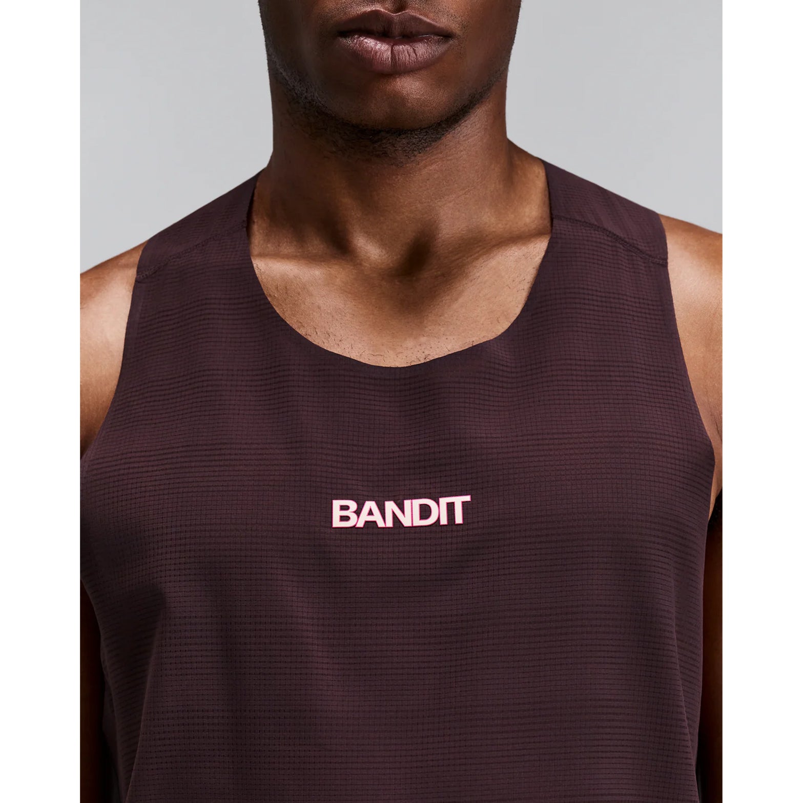 Men's Bandit CoolGrid Training Singlet with Flopack Espresso close-up of front showing CoolGrid smooth breathable fabric with high neckline and two-tone reflective Bandit graphics