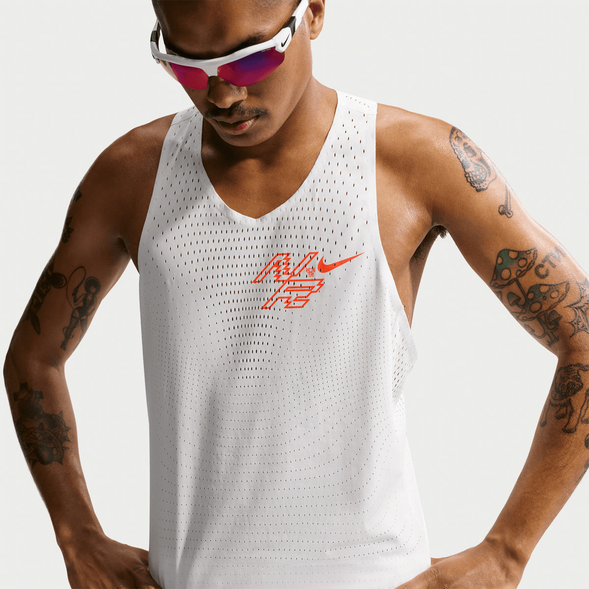 Nike AeroSwift men's Dri-FIT ADV running singlet in Summit White — closeup showing summit white open-hole fabric ventilation pattern, Dri-FIT ADV moisture-wicking construction and bonded collar seam detail for chafe-free racing