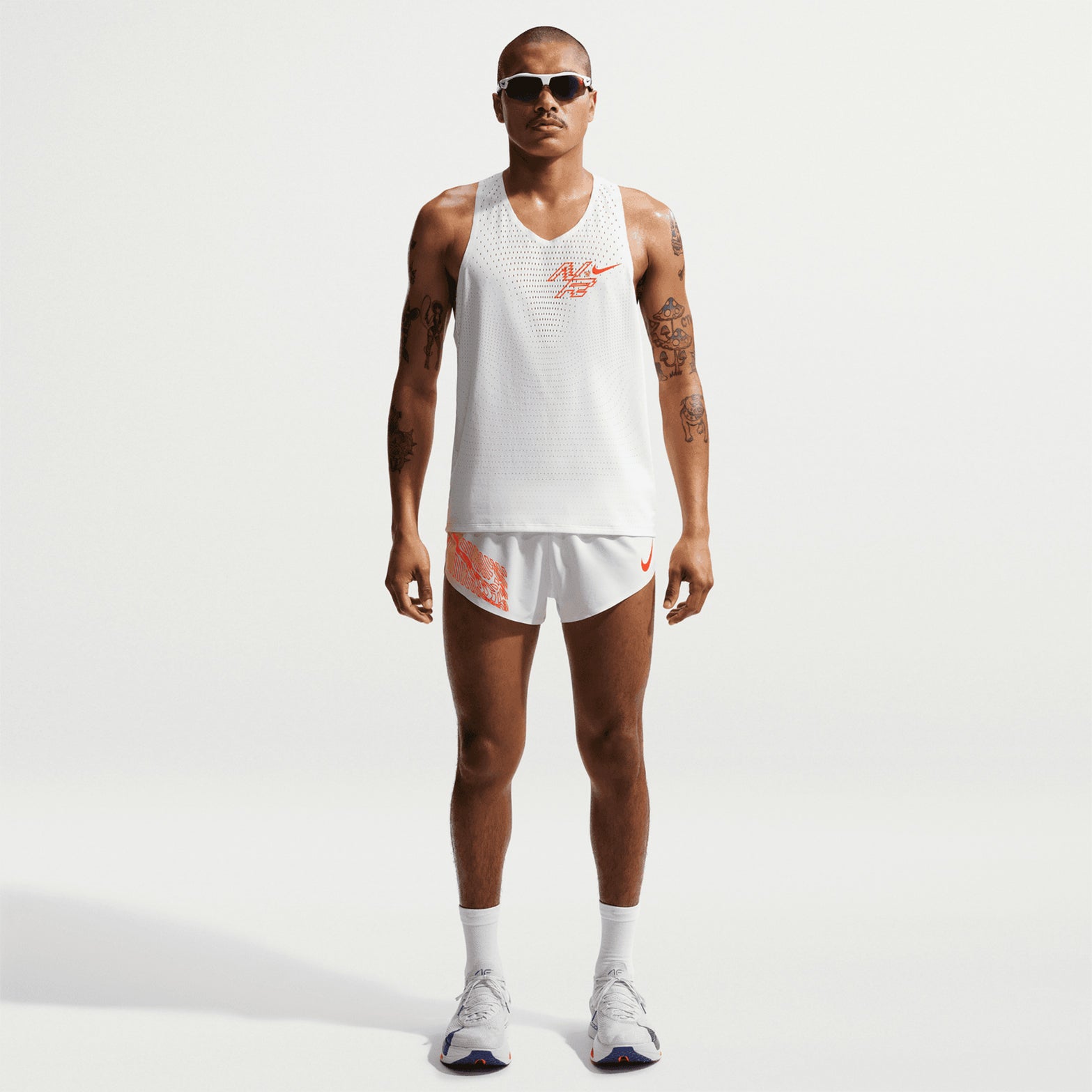 Nike AeroSwift men's Dri-FIT ADV running singlet in Summit White — full body front view worn on model showing summit white Dri-FIT ADV technology, data-driven open-hole ventilation and streamlined singlet construction
