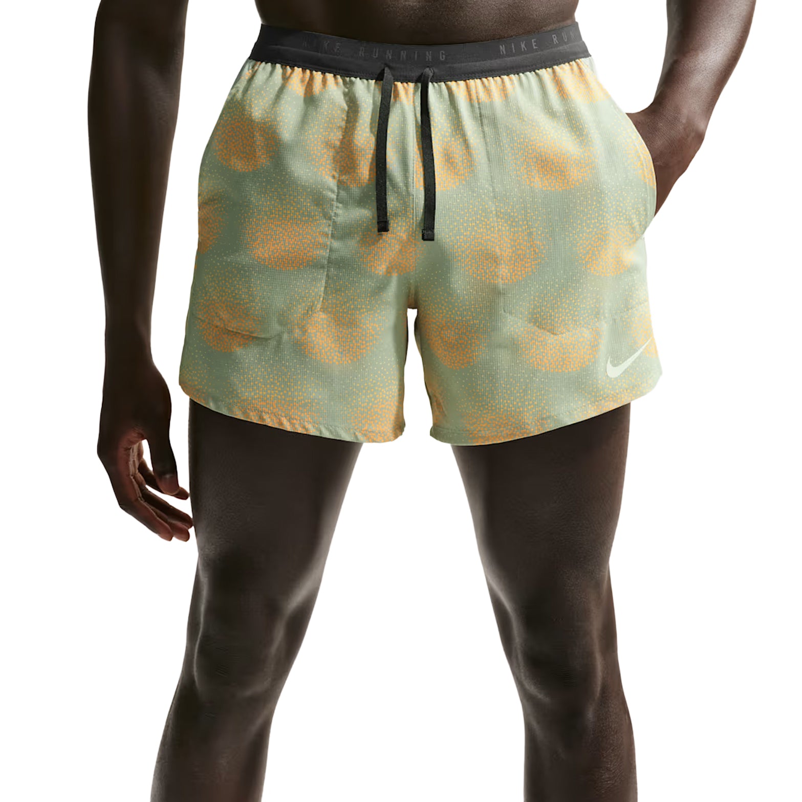 Nike Stride men's Dri-FIT 5 inch shorts in Jade Horizon — front view worn on model showing jade horizon lightweight woven fabric with narrow waistband, side pockets and shallow rise construction