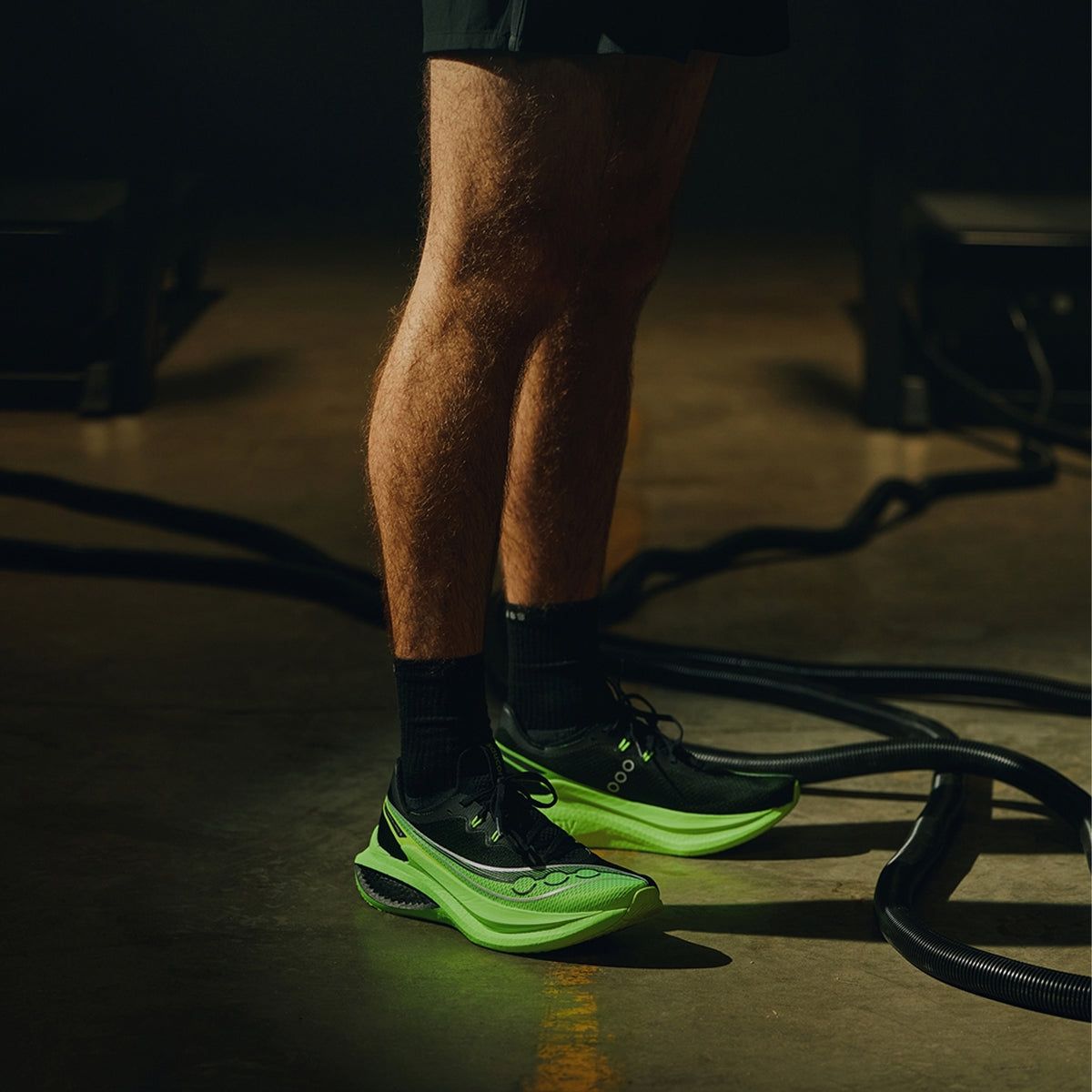 Men's Saucony Endorphin Pro 5 Running Shoes worn by male runner showing carbon-plated super foam construction with PWRRUN PB and PWRRUN HG layers for race day performance