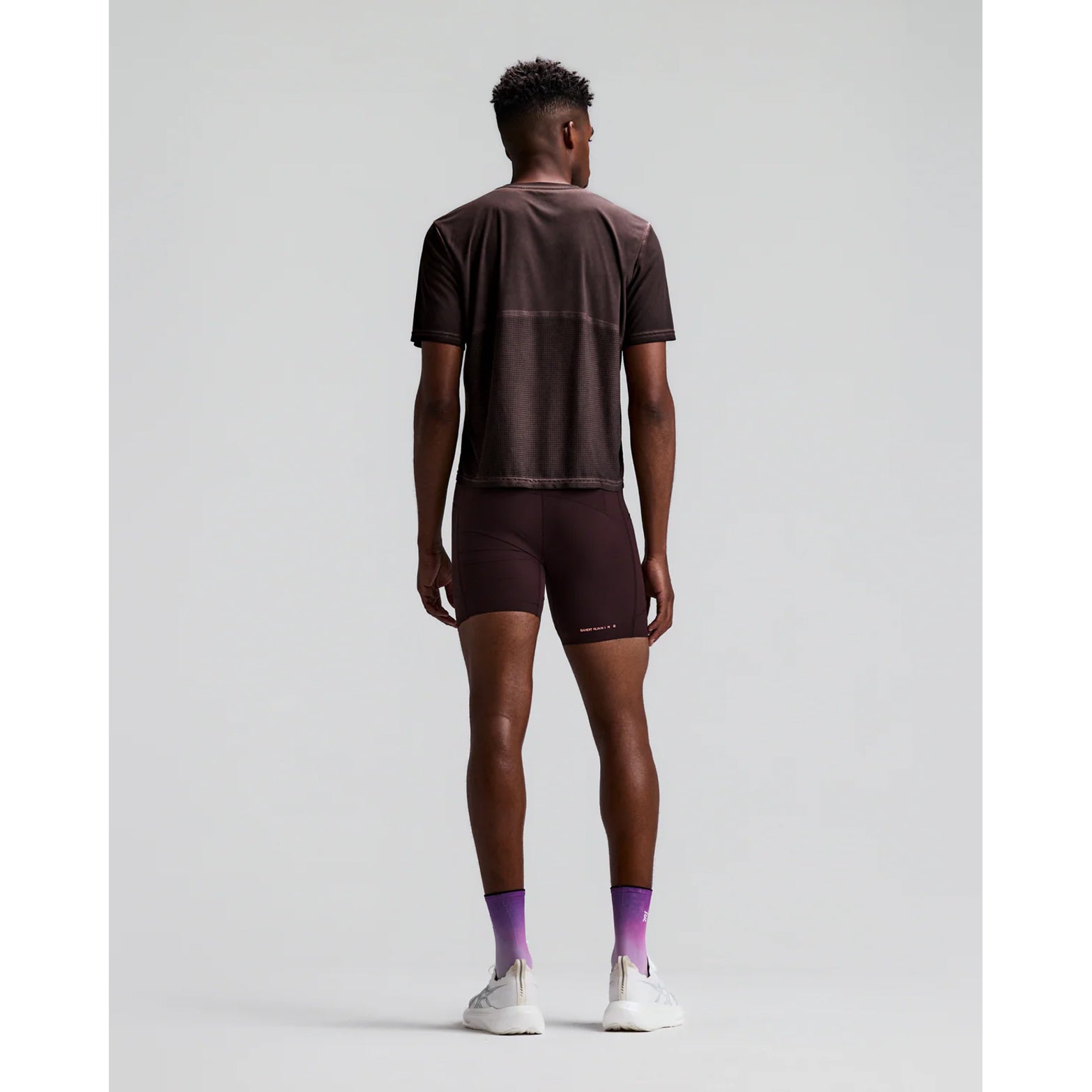 Men's Bandit FrioSoft Perforated Box Tee Espresso back full body view on male runner showing perforated panel construction with FrioSoft moisture-wicking fast-drying fabric and SaltFade vintage finish