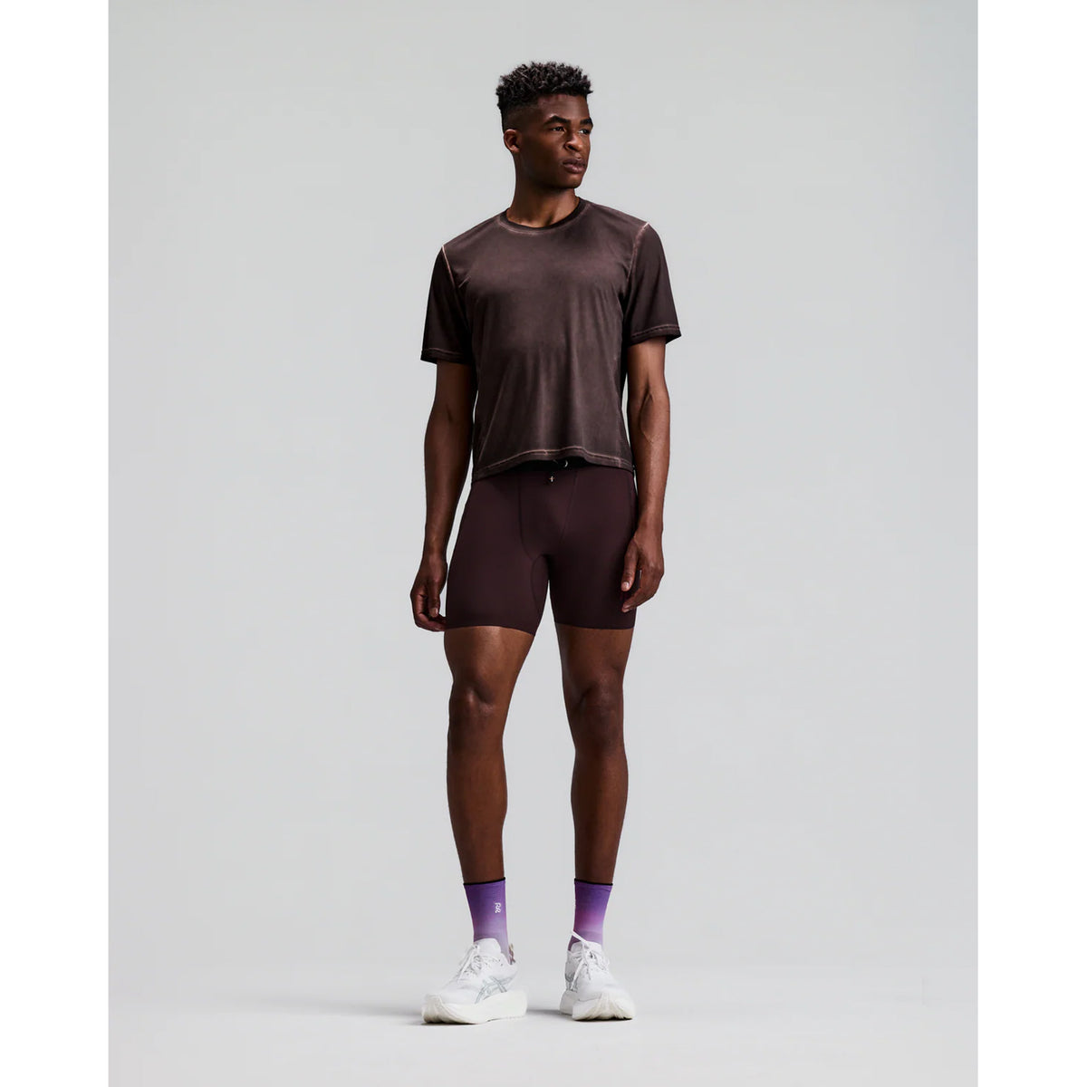 Men's Bandit FrioSoft Perforated Box Tee Espresso front full body view on male runner showing boxy silhouette with FrioSoft lightweight flowy fabric and SaltFade vintage technique for warm weather running and casual wear