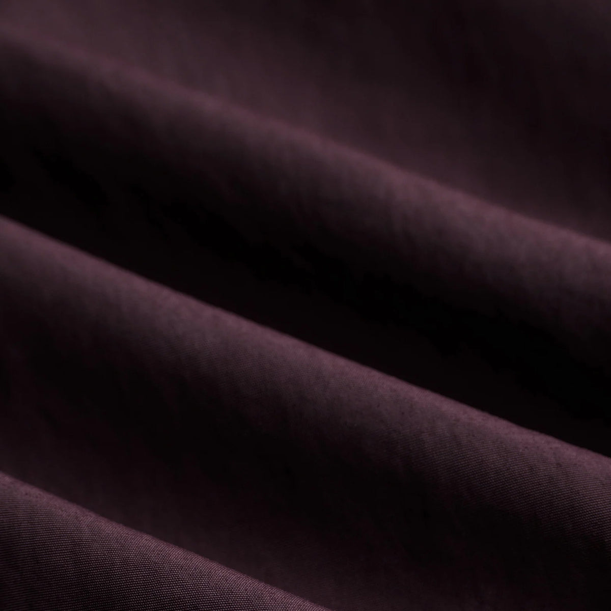 District Vision Men's Half Zip Nylon Windbreaker Blackberry close-up of 123gsm Japanese recycled nylon showing water-resistant single-layer construction with non-PFC Durable Water Repellent treatment for variable weather running
